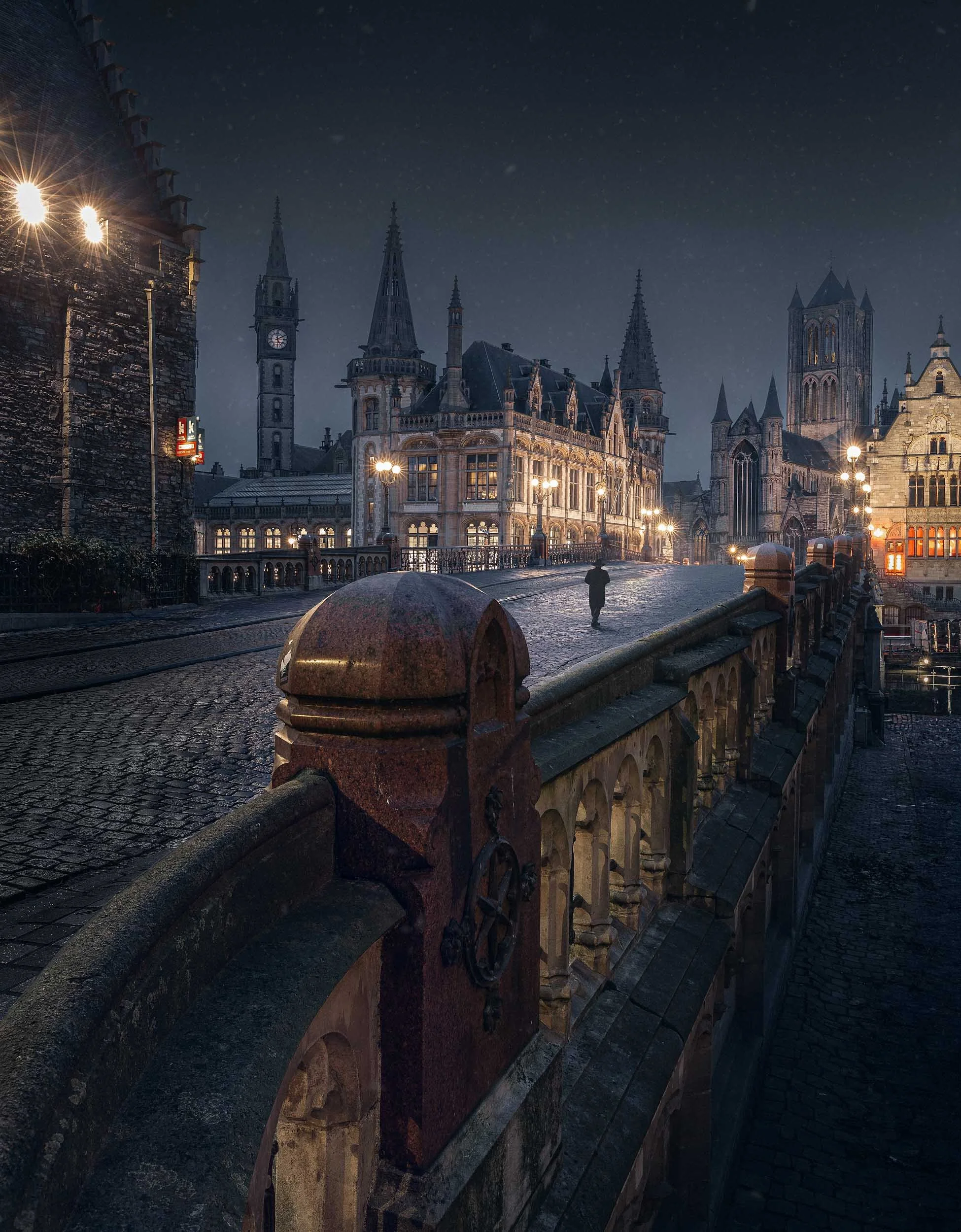 Moody night image of a man walking in the city of Ghent, Belgium. 