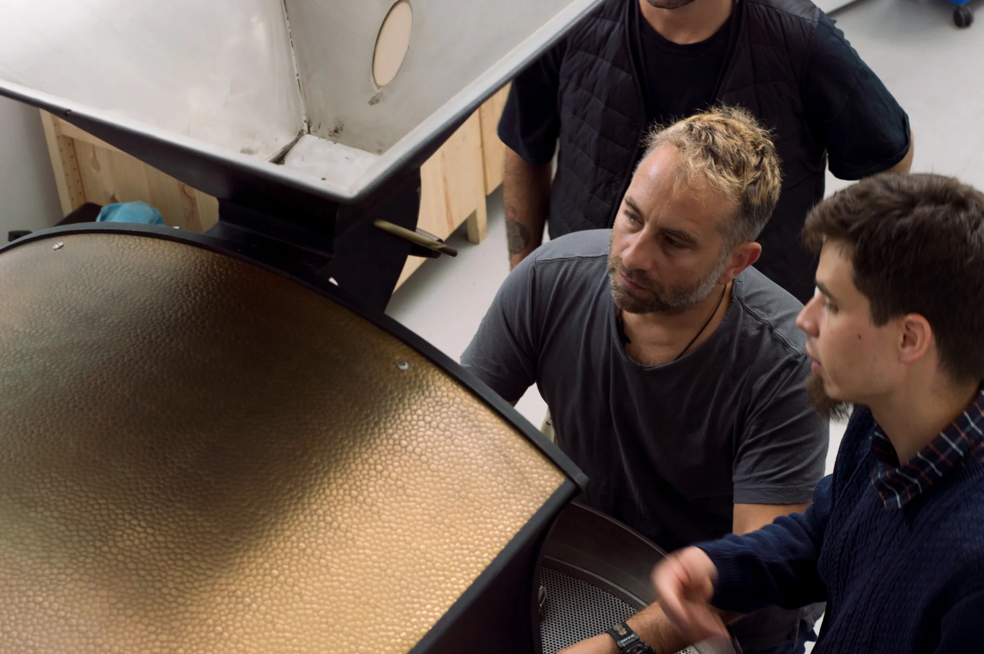Director Edy Piro and Head roaster, Julian configuring the machine.