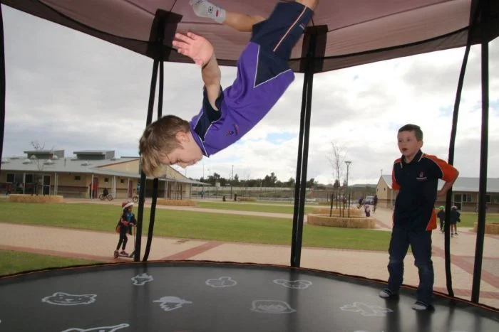 PHOTO: Kids at Honeywood Primary School are head over heels for their trampolines. (ABC News: Rebecca Carmody)