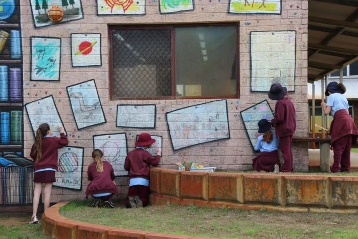 PHOTO: Creative students have left their mark on a wall at West Greenwood Primary School. (ABC News: Rebecca Carmody)