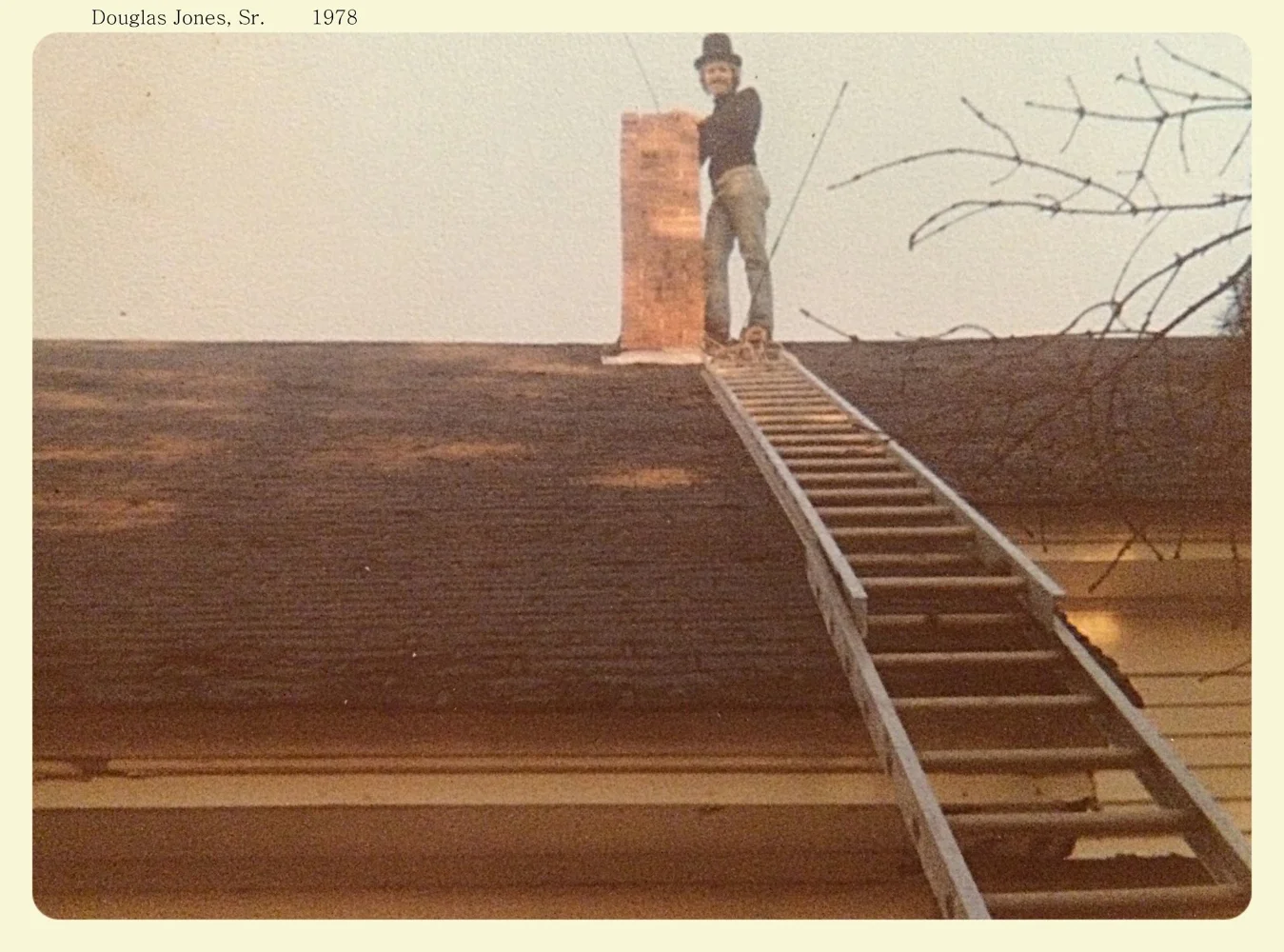 Doug Sr. sweeping a chimney in a traditional top hat back in 1978