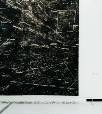 kiefer's night sky resembles an archive, where each star is identified by its code in the nasa classification system. lines traced to join disparate points draw imaginary constellations. at the foot of the canvass, on the floor, lie glass tabs with codes inscribed: they are the fallen stars, a bridge between the sky above and the ground below. comparison with the visual layout in the works entitled sternen-lager (star storehouses) suggests some reference to the holocaust, the numbered codes reminiscent of the numbers tattooed onto the arms of the jews at the nazi camps. the memory of post events entwines with cosmic visions. compositionally, the work is based on stratified pictorial matter and the fragmentation of formal elements. sternenfall by anselm kiefer. 1998
