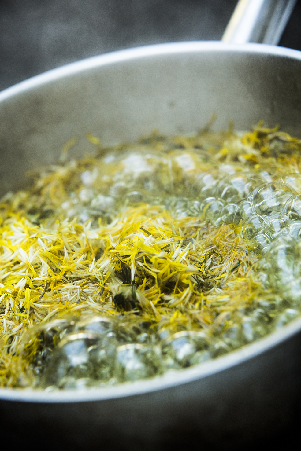 Strain the petals and let the remaining liquid sit over night. Add approximately the same weight of sugar as liquid to the dandelion water and heat gently until it thickens.