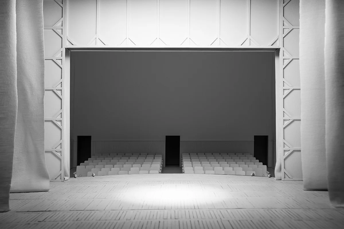 A small model of a theater, the perspective is from the stage