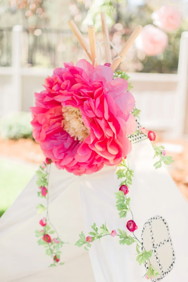 A recent client and I crafted up a bright and cheery first birthday that was equal parts boho and preppy. She used a paper-flower decorated tee pee as the photo booth backdrop which made for fantastic photos. Photo Courtesy of Amira Gray Photography.