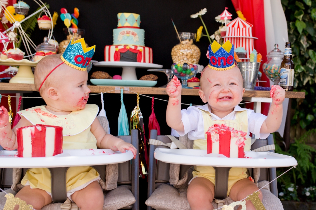 This dessert table you see behind these sweethearts was no doubt the pièce de résistance of the entire bash. It not only made a statement but it served as a fantastic backdrop as the guests of honor dove into their smash cakes. Photo Courtesy of Amy Anderson of Nicole Paulson Photography