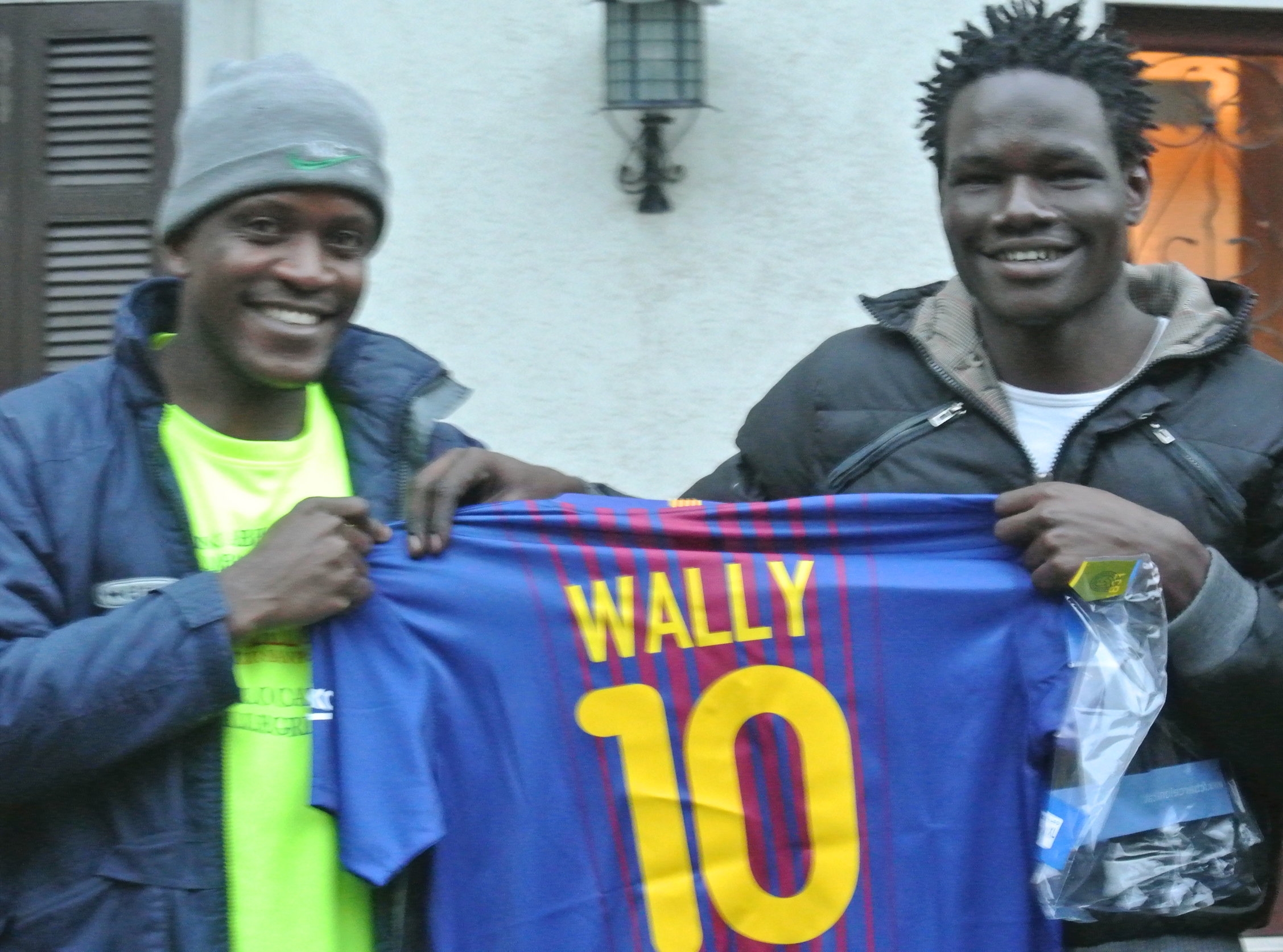  Sama (L) with Wally (R) and his Barca jersey at their housing in Bergamo province, November 2017. 