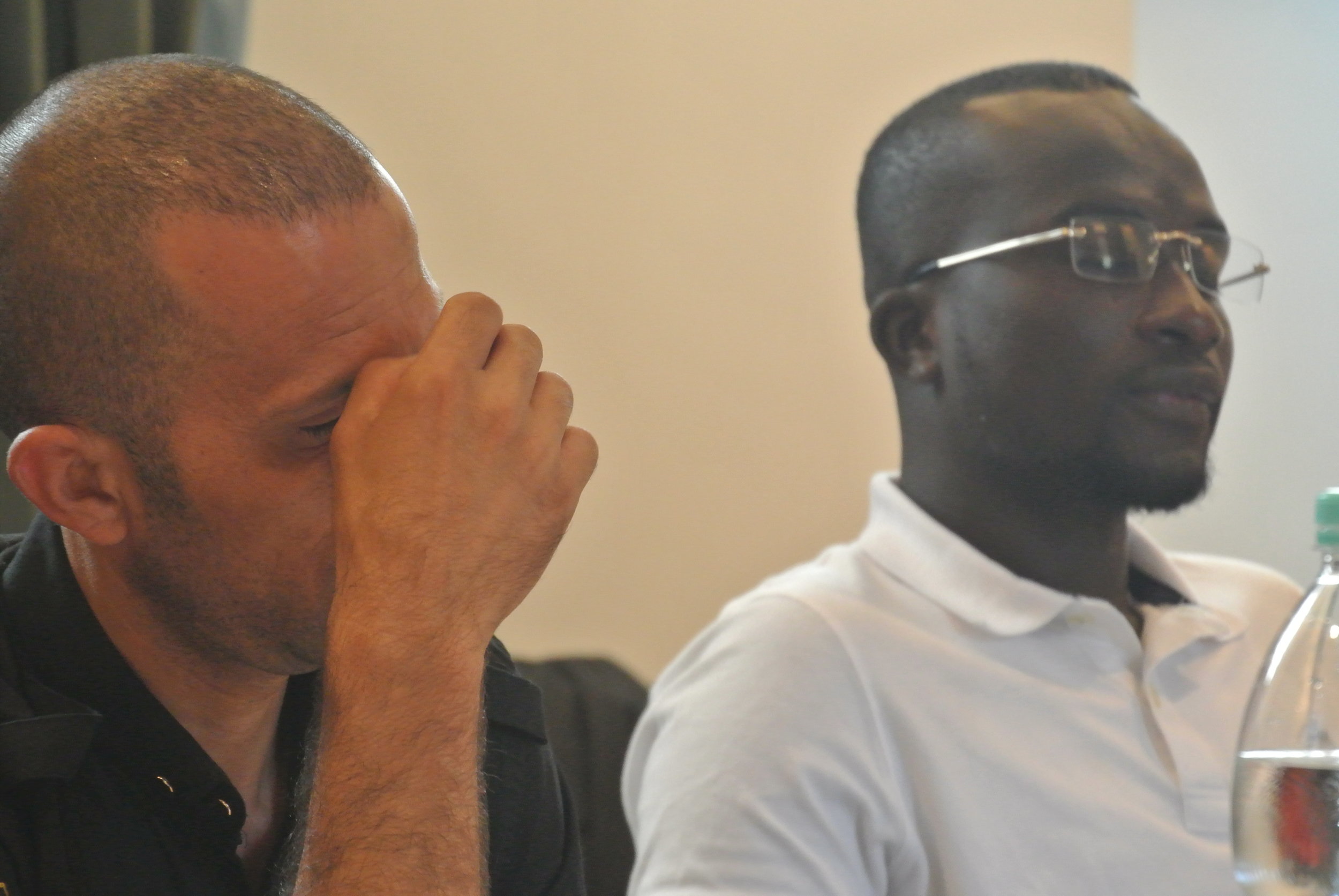  Walid grips his brow while listening to Bakary. The Embassy of Switzerland, Rome. 11 June 2018. 