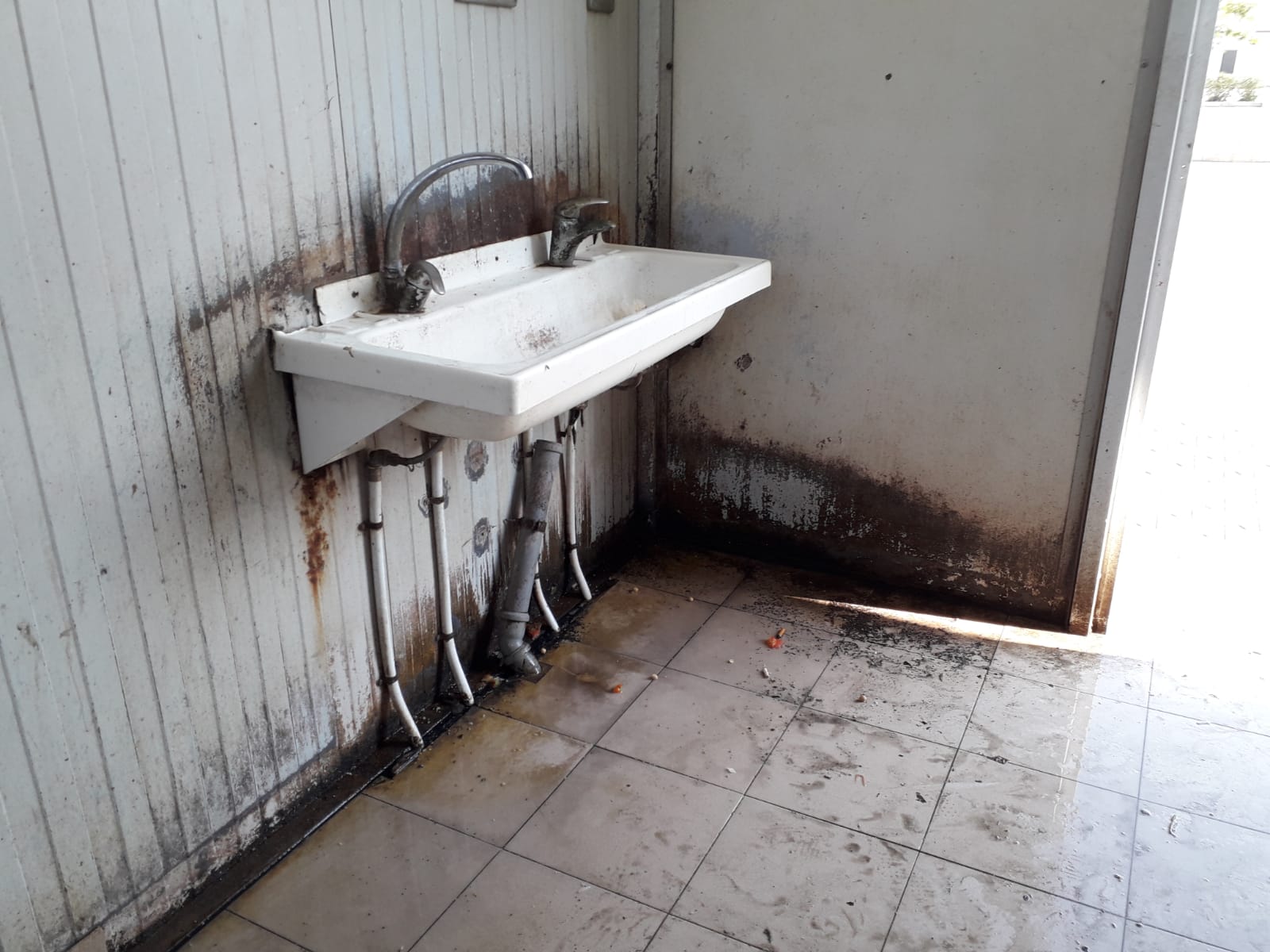 A housing camp bathroom, near Foggia, Italy. July, 2018. © Pamela Kerpius