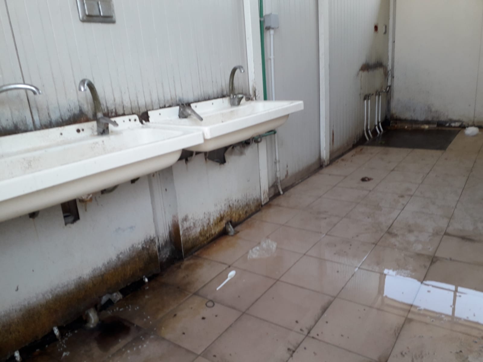   An unclean camp bathroom, near Foggia, Italy. July, 2018. © Pamela Kerpius  