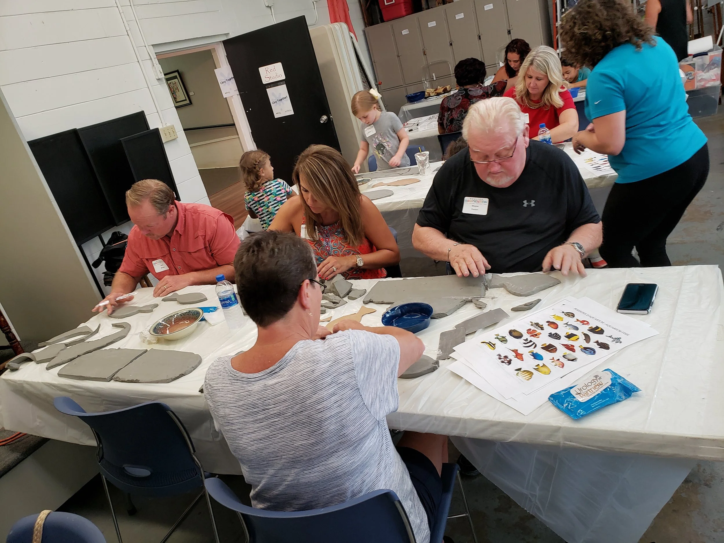 "Clay Together" workshop where the community makes some fish for the mosaic