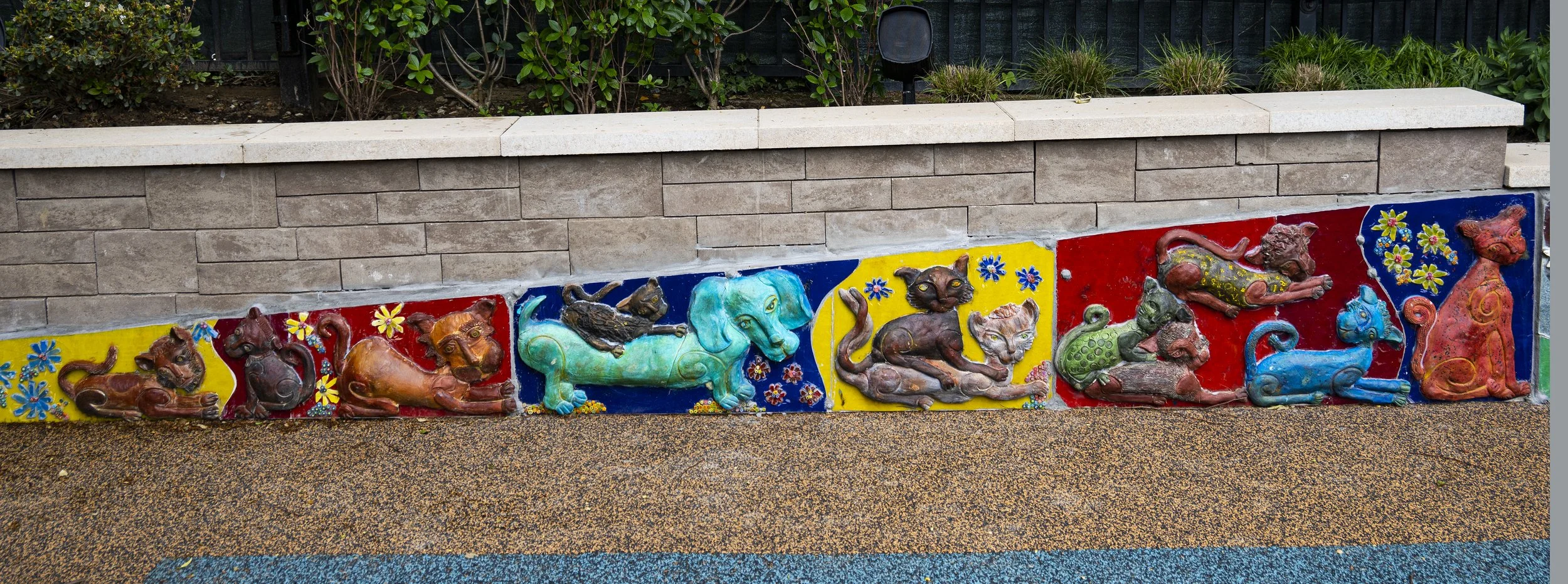  Detail close-up of the back wall, featuring a series of playful cats in various poses. 