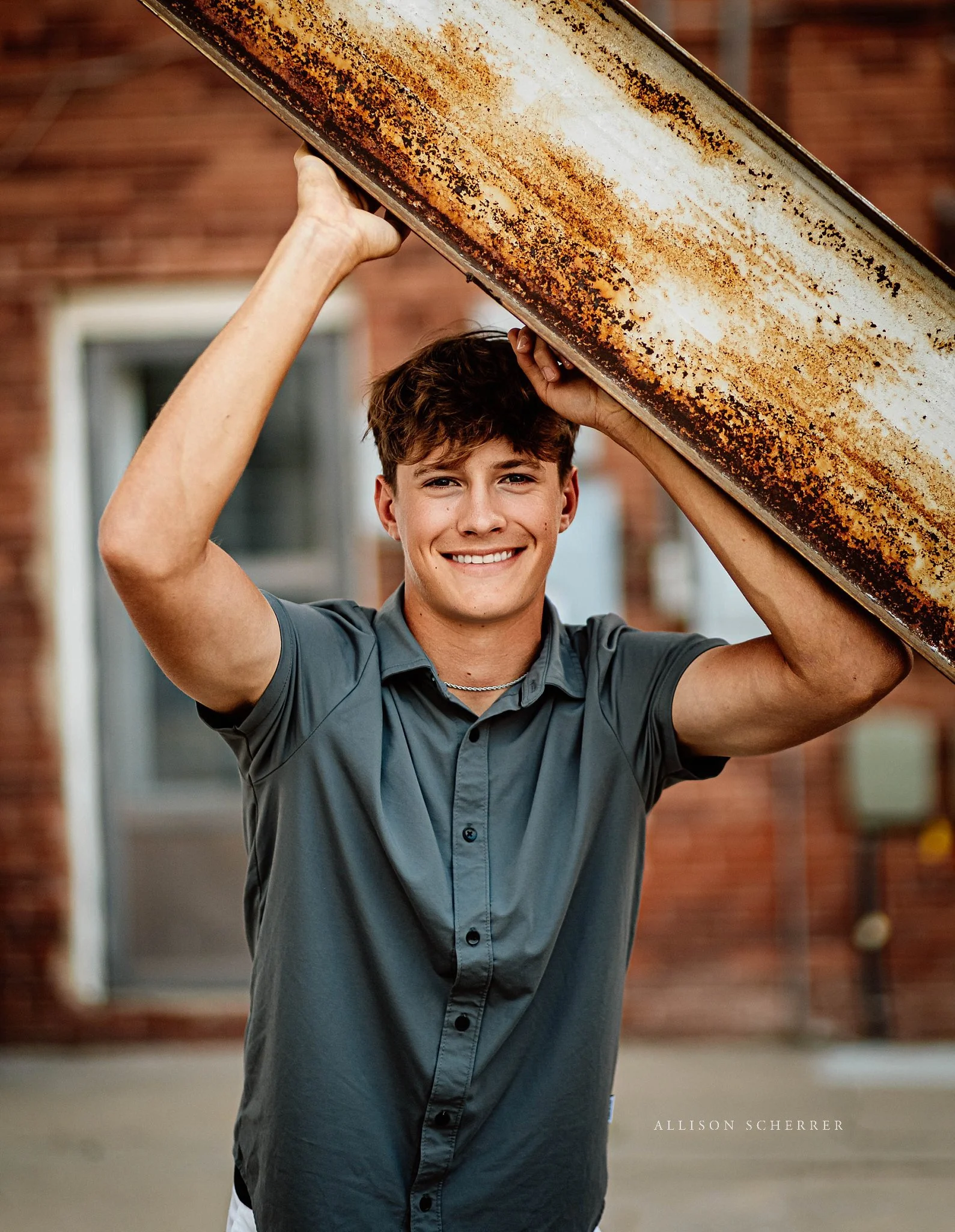 Mother photographing her son’s senior portraits in Garden City