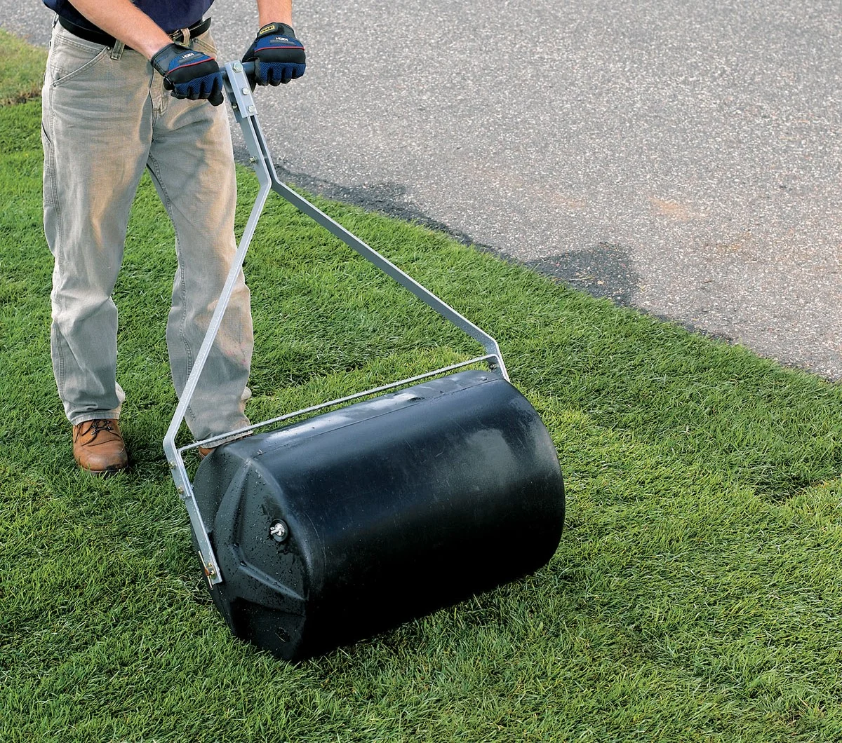 4. Use a sod roller to tightly press the sod into the soil, which gives the roots immediate access to moisture.