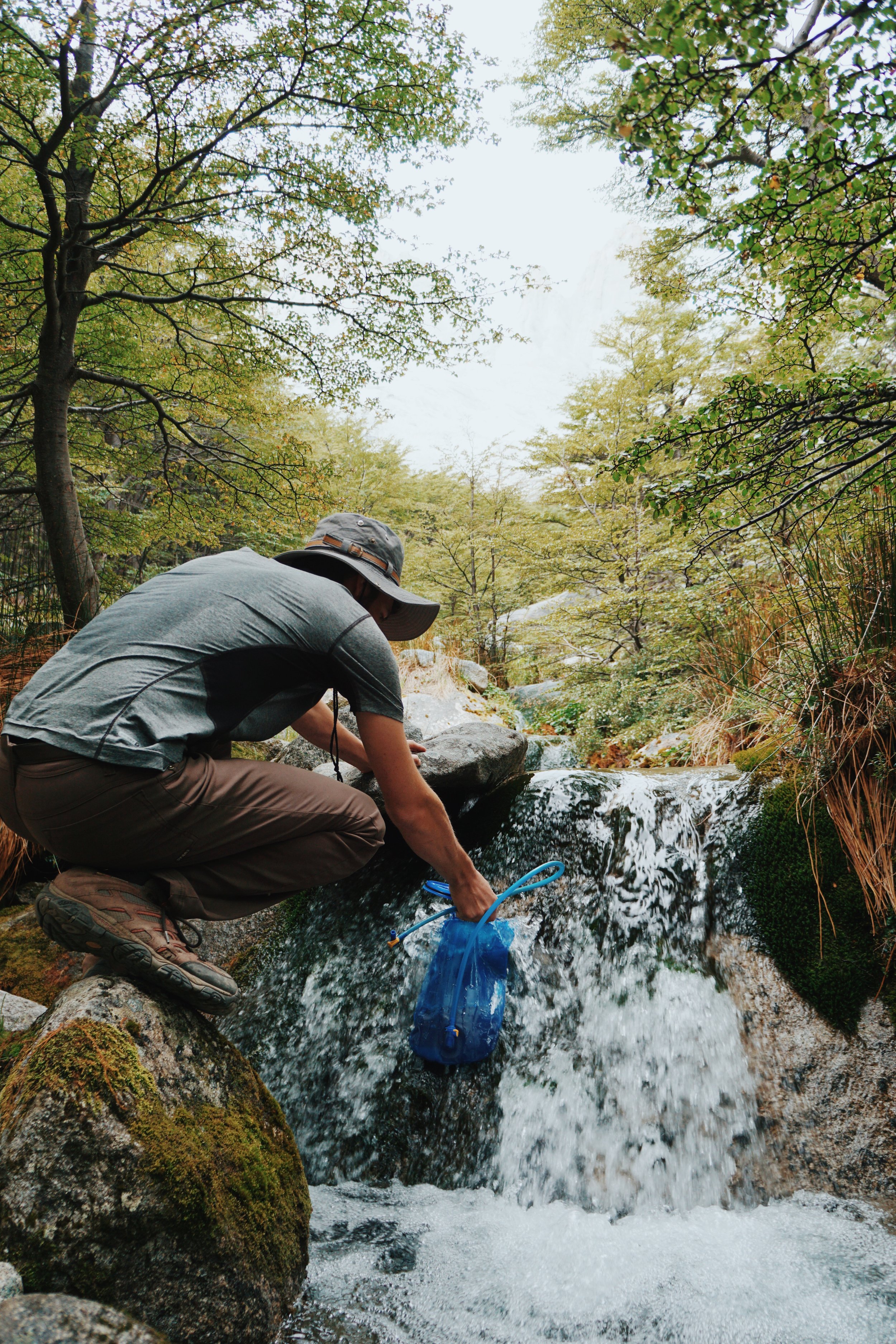 Drinking unfiltered water straight from the stream.