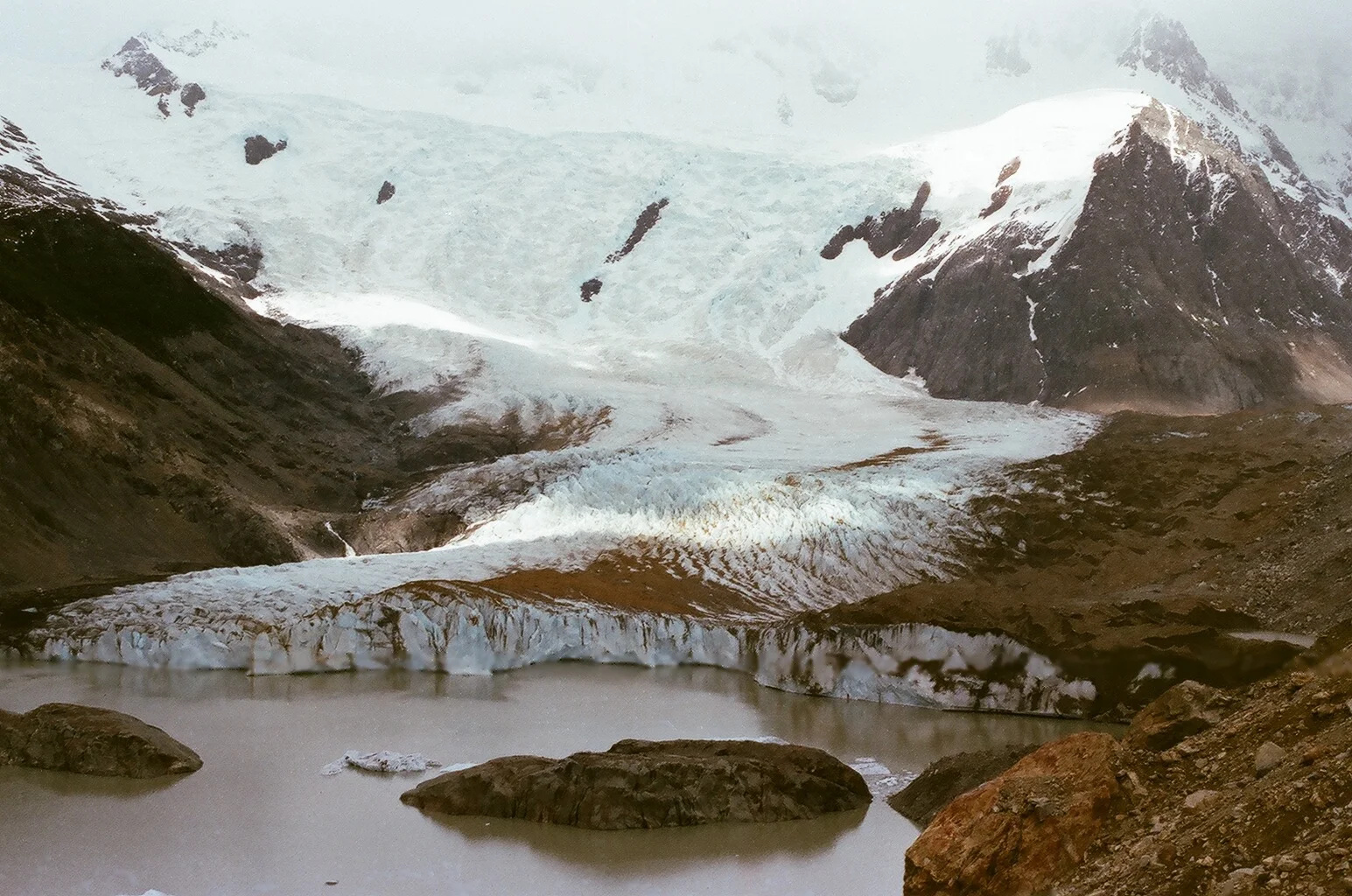 Snow and earth covers a glacier near El Chaltén , Patagonia, Argentina.