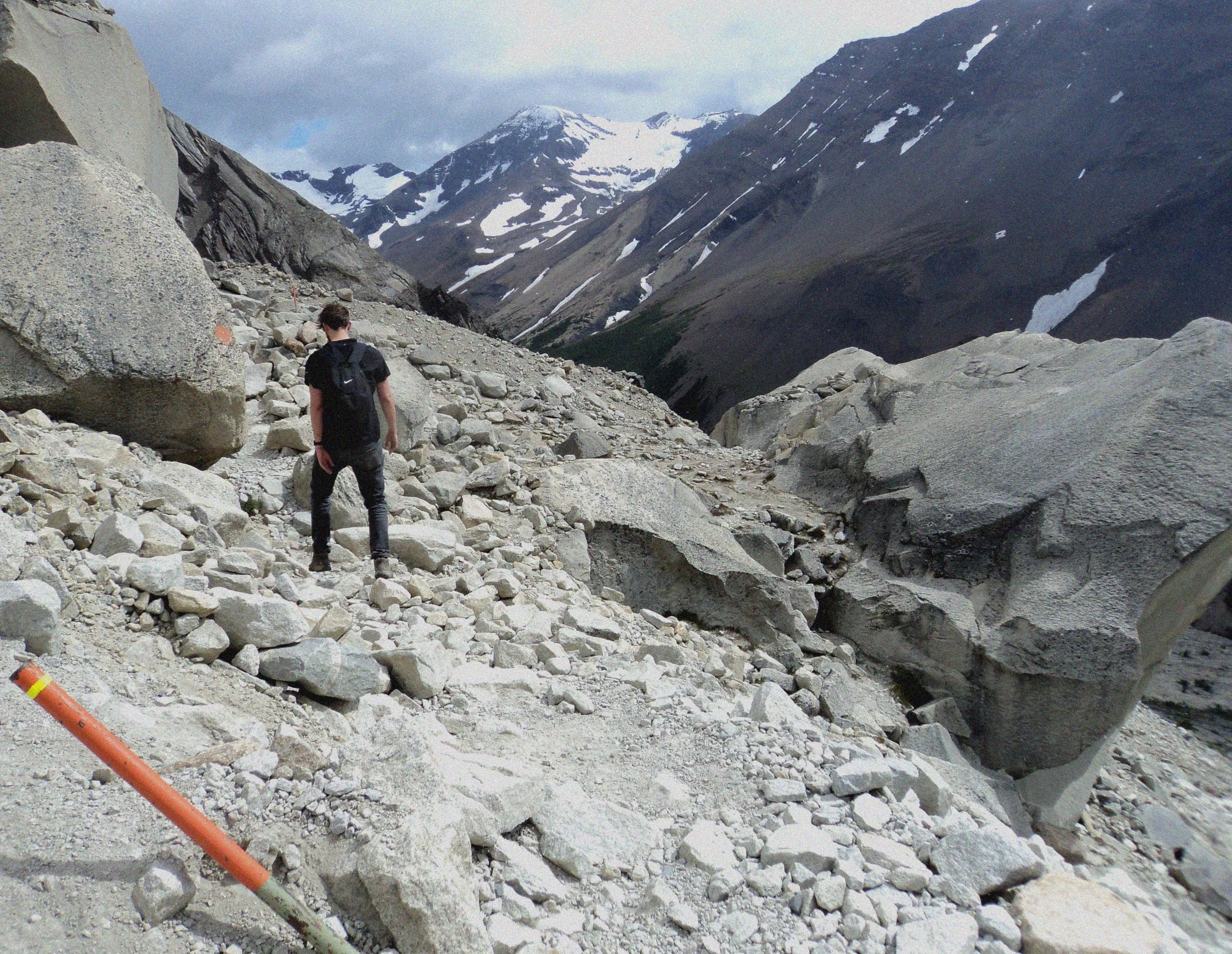 Mark scrambling over rocks on the Torres Del Paine, Patagonia, Chile.