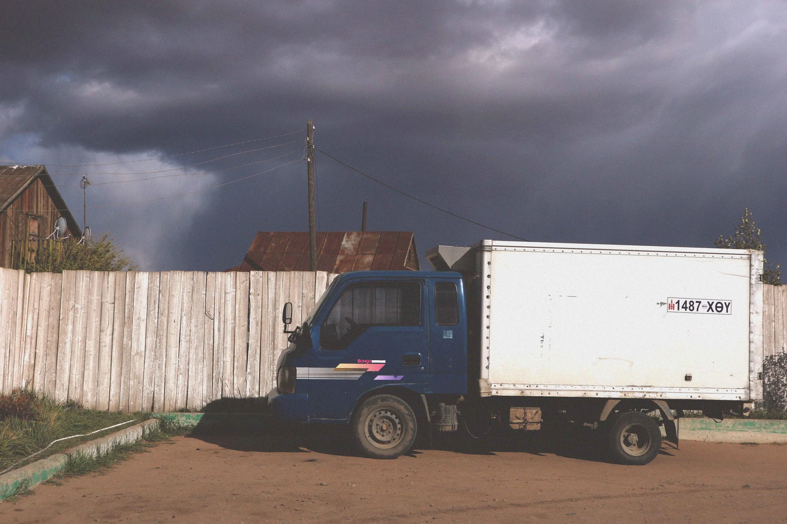 mongolian van in a stormy moody sky storm is coming weather grey clouds mongolia