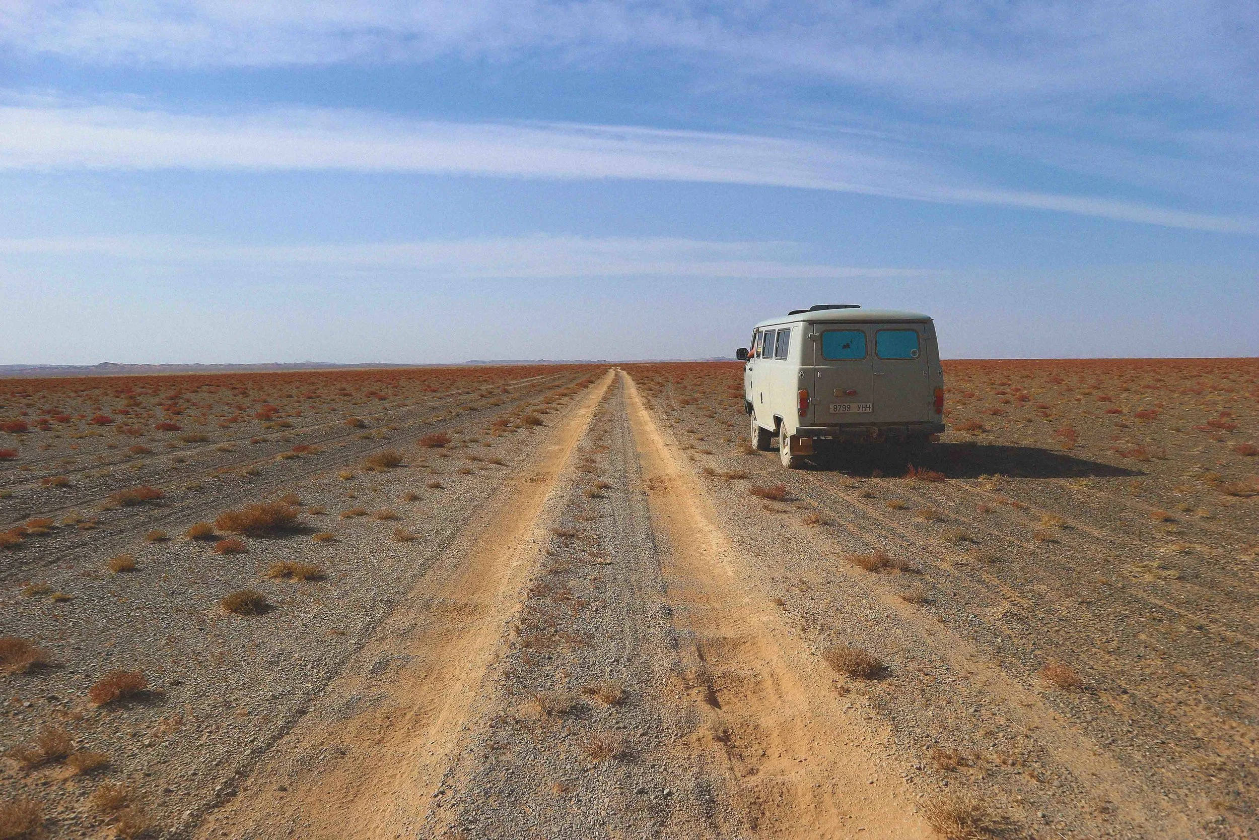 on the road on a mongolia tour in the middle of the gobi desert in mongolia red sands van