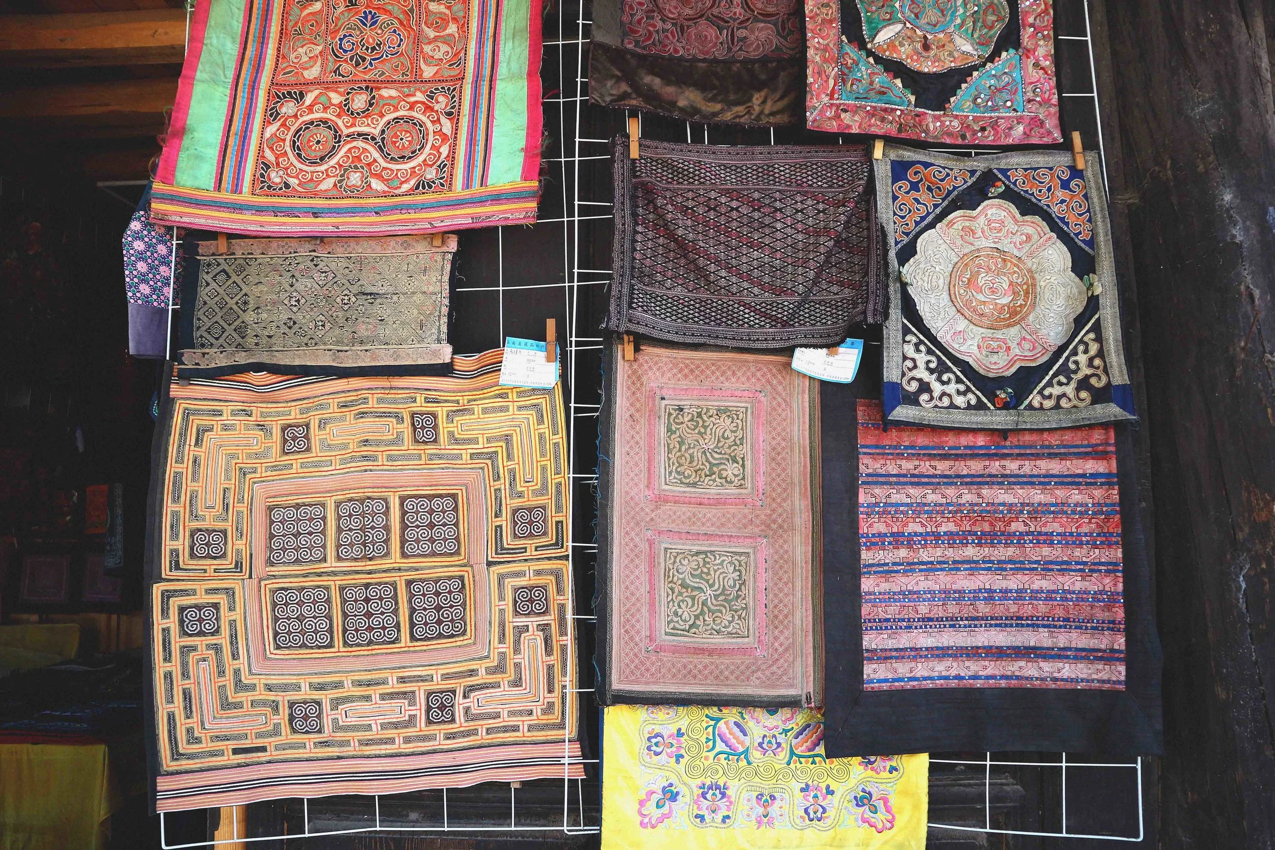 The hundred of antique embroideries for sale in Basha, all priced at a few hundred dollars a piece