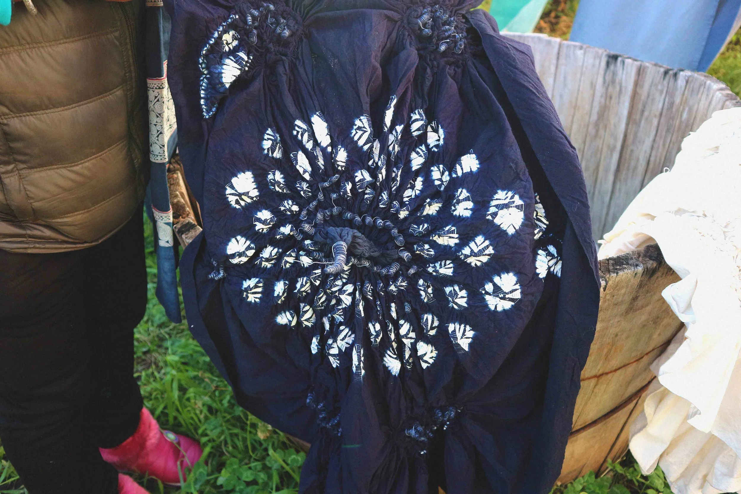 After dying, she has to untie the threads to reveal the un-dyed sections