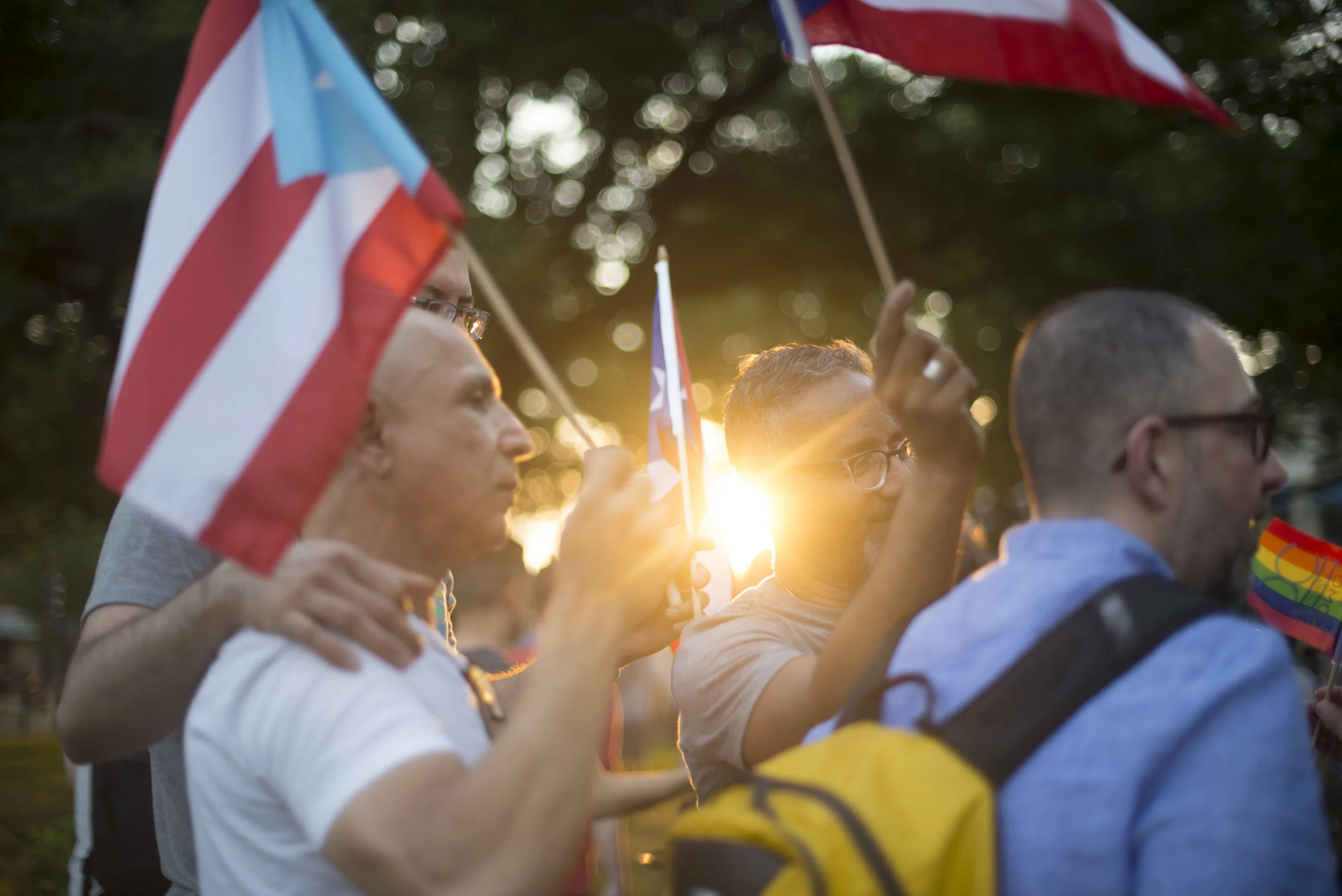  Men hold Cuban flags after a memorial for the Pulse nightclub massacre at Dupont Circle in Washington, D.C. on June 12, 2017.&nbsp;The victims of the attack in Orlando, FL, were largely Hispanic, and one Cuban-American man was killed. 