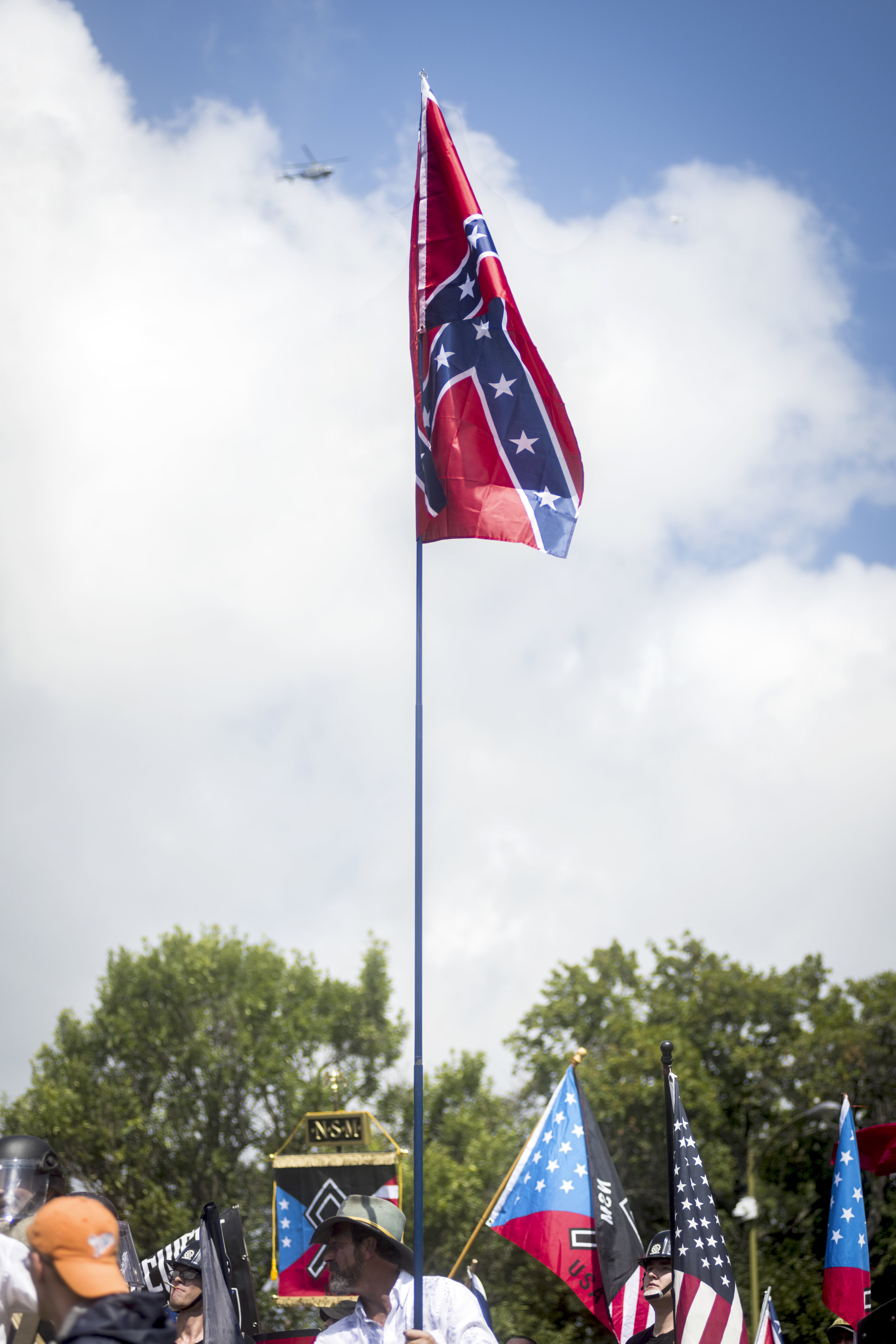  A confederate flag is hoisted on a large pole, and below are flags from the National Socialist Movement, a white civil rights movement. 