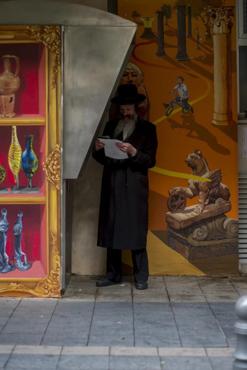  A man pauses at a telephone booth to read a sheet of paper in Jerusalem, Israel on December 28, 2016. 