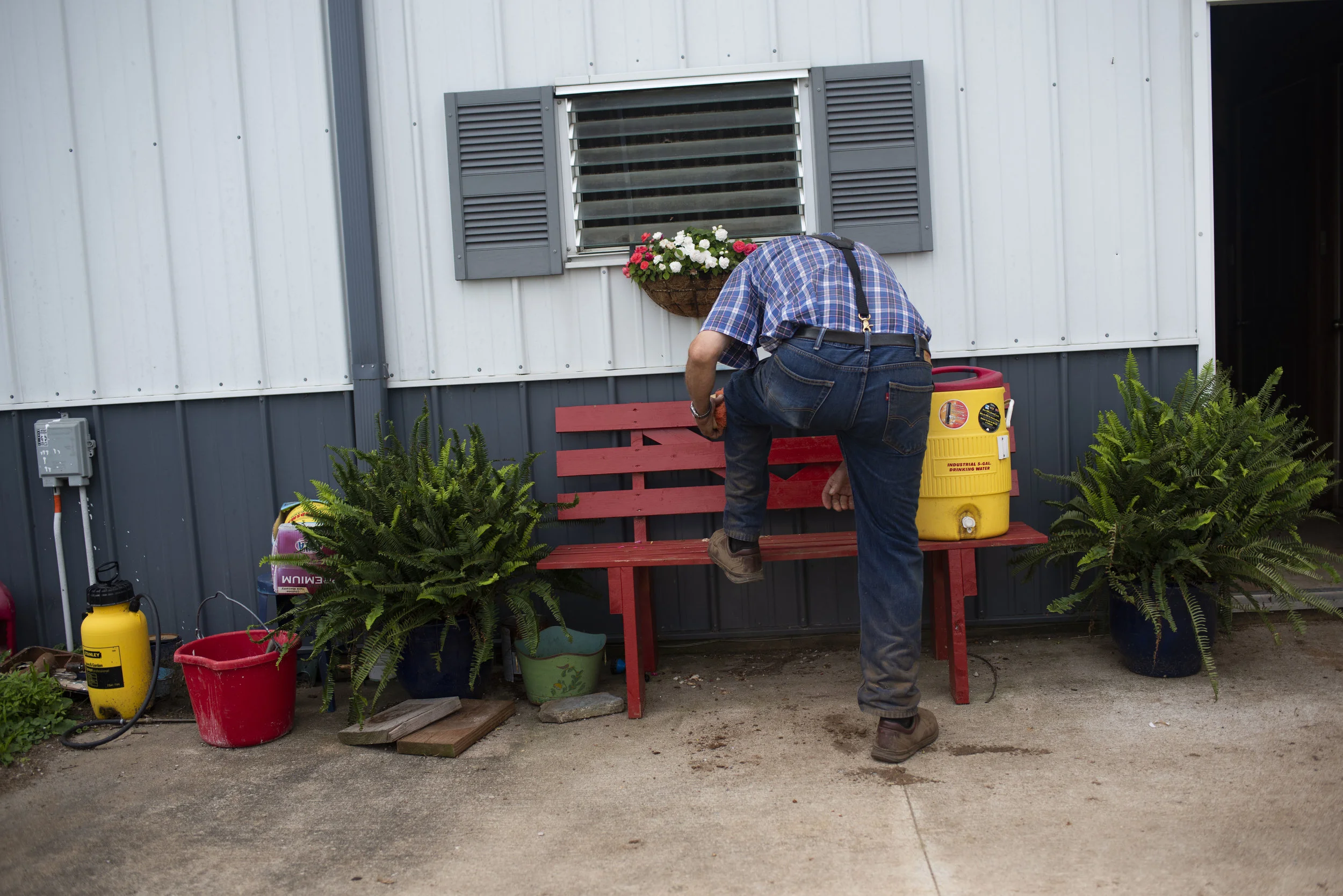  Jim carefully dusts off his brown leather shoes, a pair he's worn for daily for almost 8 years, before heading to Walmart in Mexico, Mo. on June 19, 2019. 