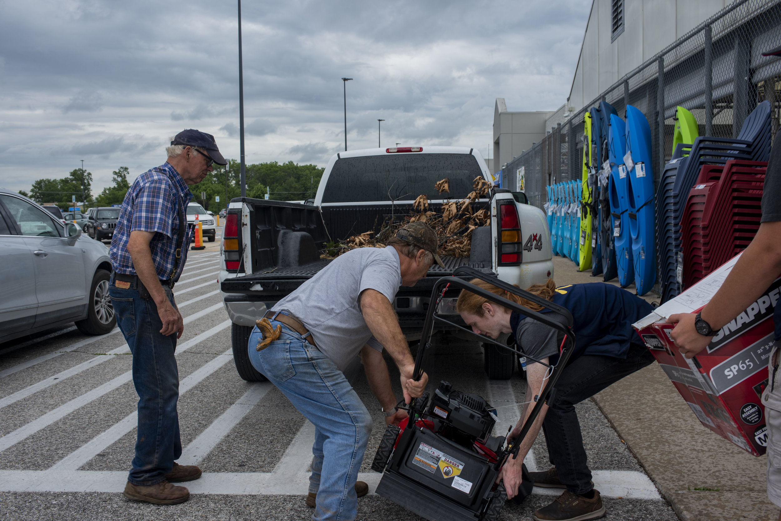  Jim directs as one of his trainers and a Walmart employee loads a new self-propelled lawnmower to take back to the stables on June 19, 2019. It was his second trip to Walmart that day -- he couldn’t get it going at home so he brought it back to be s