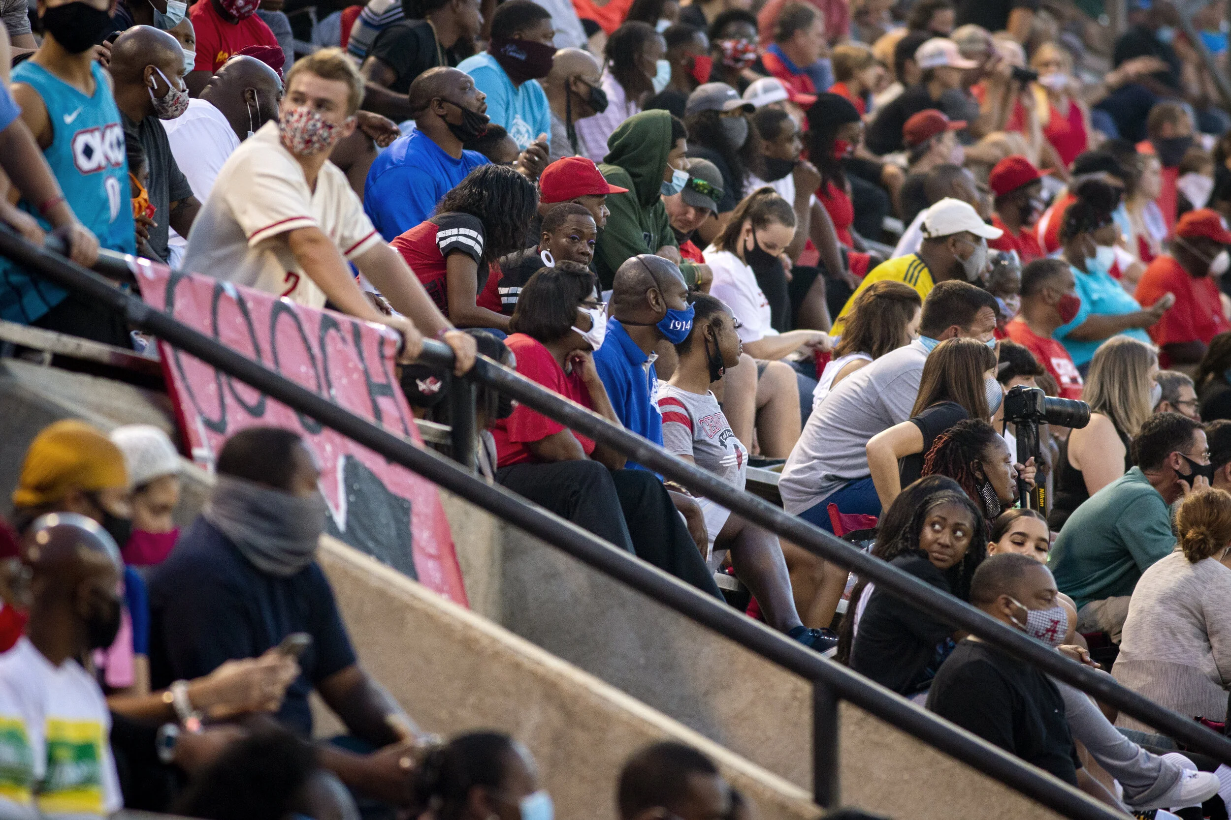  While the Garrett-Harrison Stadium broadcasted reminders to wear masks and social distance, clumps of people still gathered in the stands during Central Highs football game against the Hoover High Buccaneers on August 21, 2020, in Phenix City, Ala. 