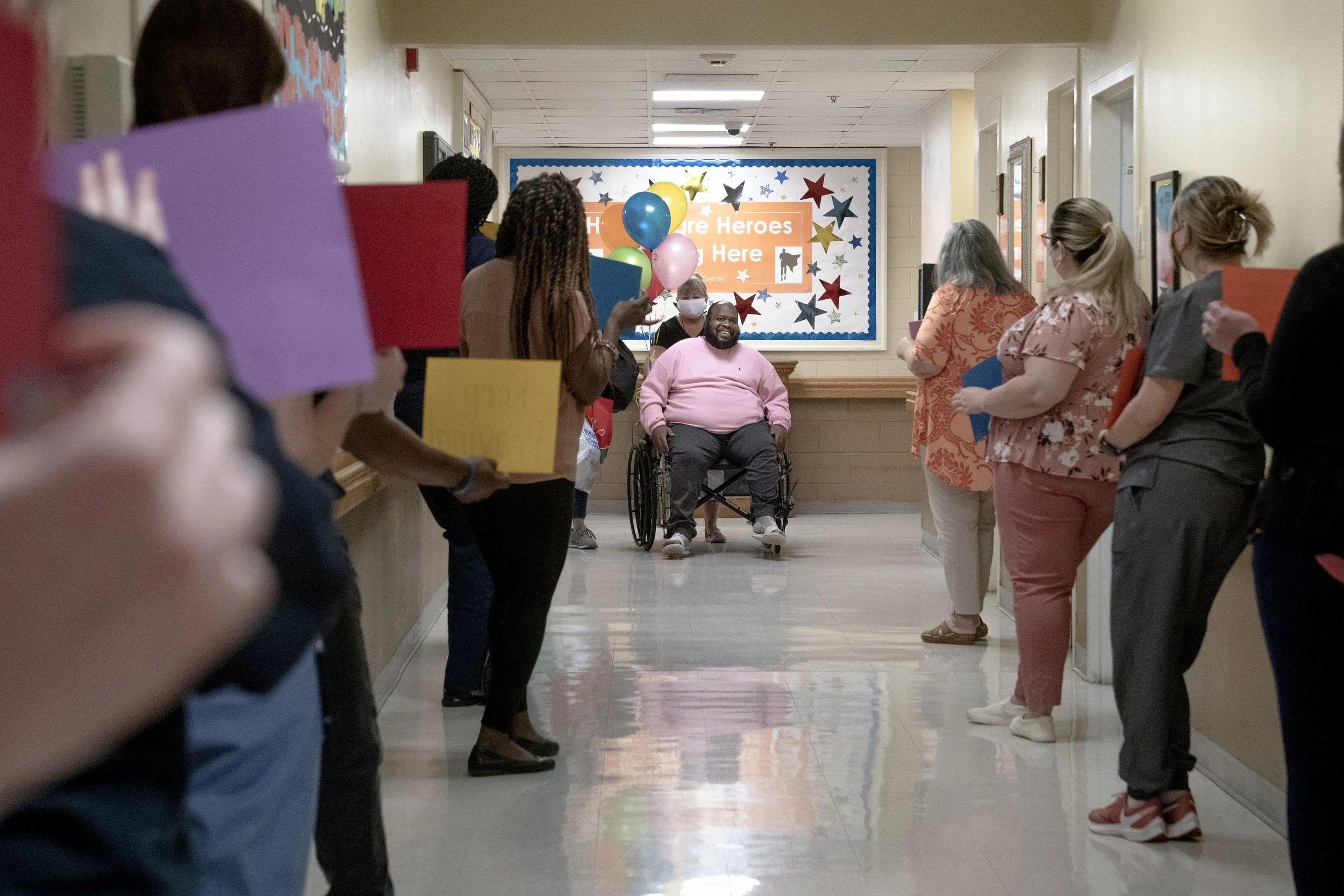 Eric Lofton’s rehabilitation team cheers for him after two months of in-house recovery from being placed on a ventilator after a COVID-19 diagnosis, at River Towne Center on May 27, 2021, in Columbus, Ga. Lofton survived 5 weeks on a ventilator and