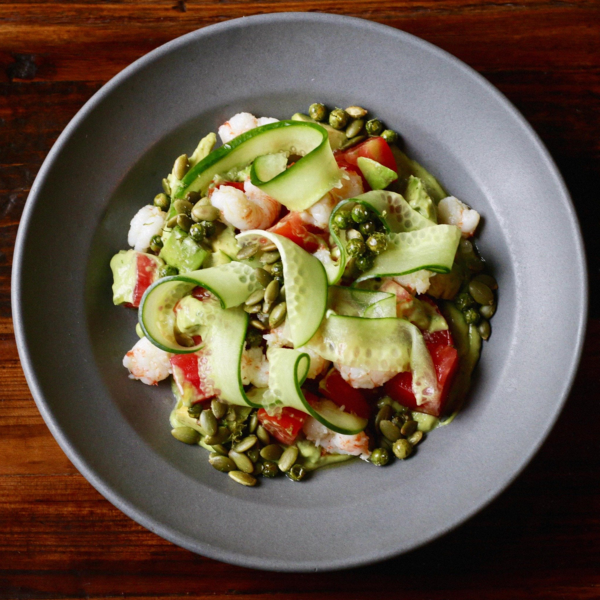 Spring shrimp salad 🍤 pickled rock shrimp, @woodlandgardensathens&rsquo; first heritage tomatoes of the season, katrina cucumbers, avocado, and pea and pepita condiment. On special tonight :)