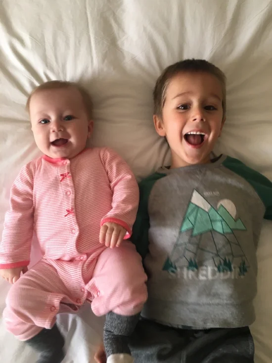 Sylvia and Leo, enjoying reveling in the vacation hotel bed in KC