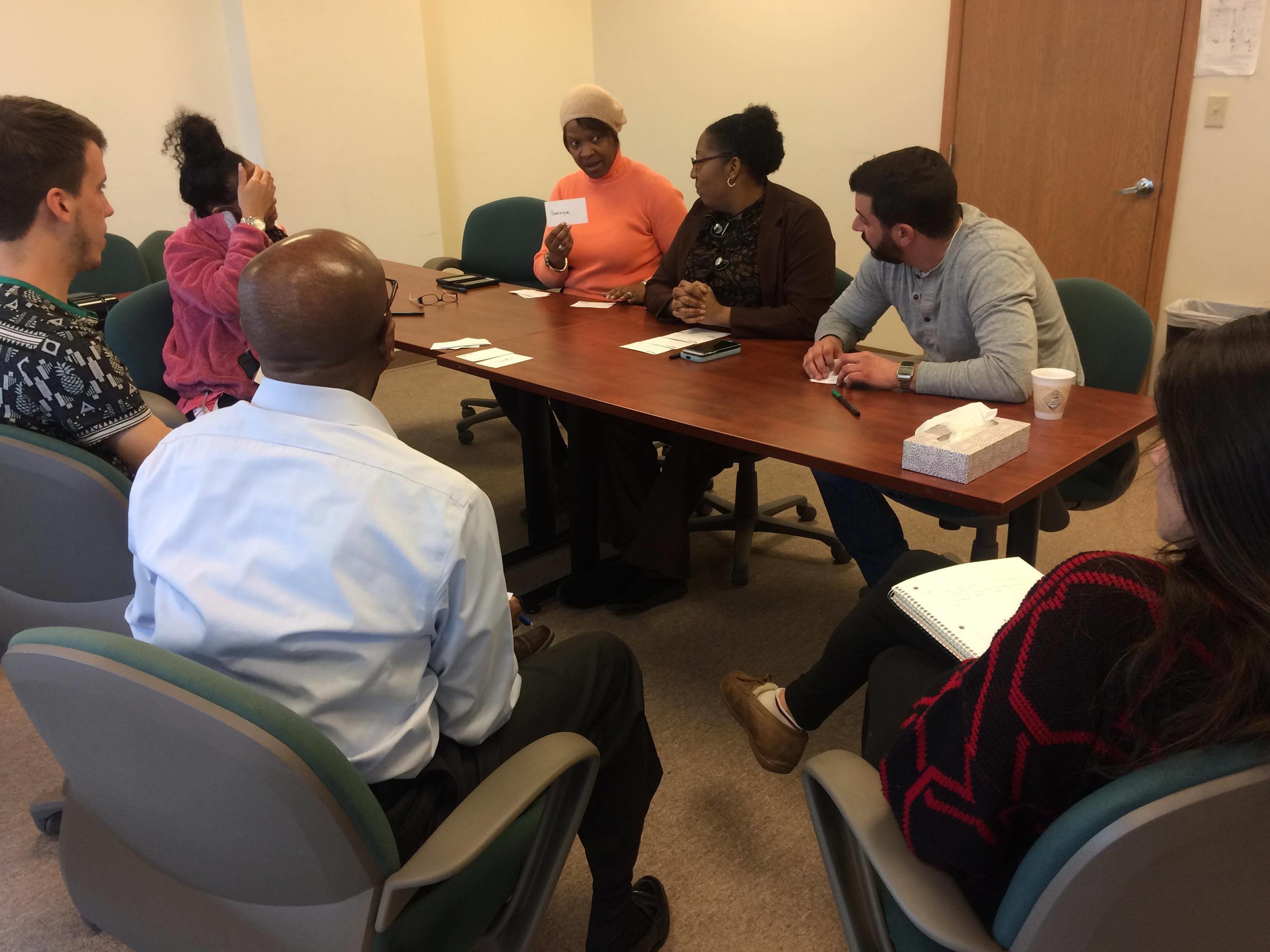Employees of local non-profit Small Seeds play an early version of the card game during a participatory design workshop.