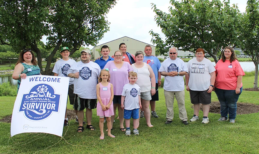 Photo Caption 18 survivors of craniopharyngioma, met up in Northside Park for a picnic Saturday. Pictured from left to right: First row: Landry Stamm (DE) and Alex Wood (MD) Second row: Chris Harsch (PA), Emily Powell (MD), Sydni Gajewski (PA) Back row: Elise Rosati (NJ), Jake Borsh (NH), Isaac Feil (NJ), Frederick Kunitz (GA), A.J. Selko (NJ), Jonas, Bilenas (PA), Jacob Reid (WV), Britanny Rinker (WV) Not pictured but in attendance: Mikey O’Connell (VA) and Christopher Ramirez (FL) Photo credit: Emily Powell Photography