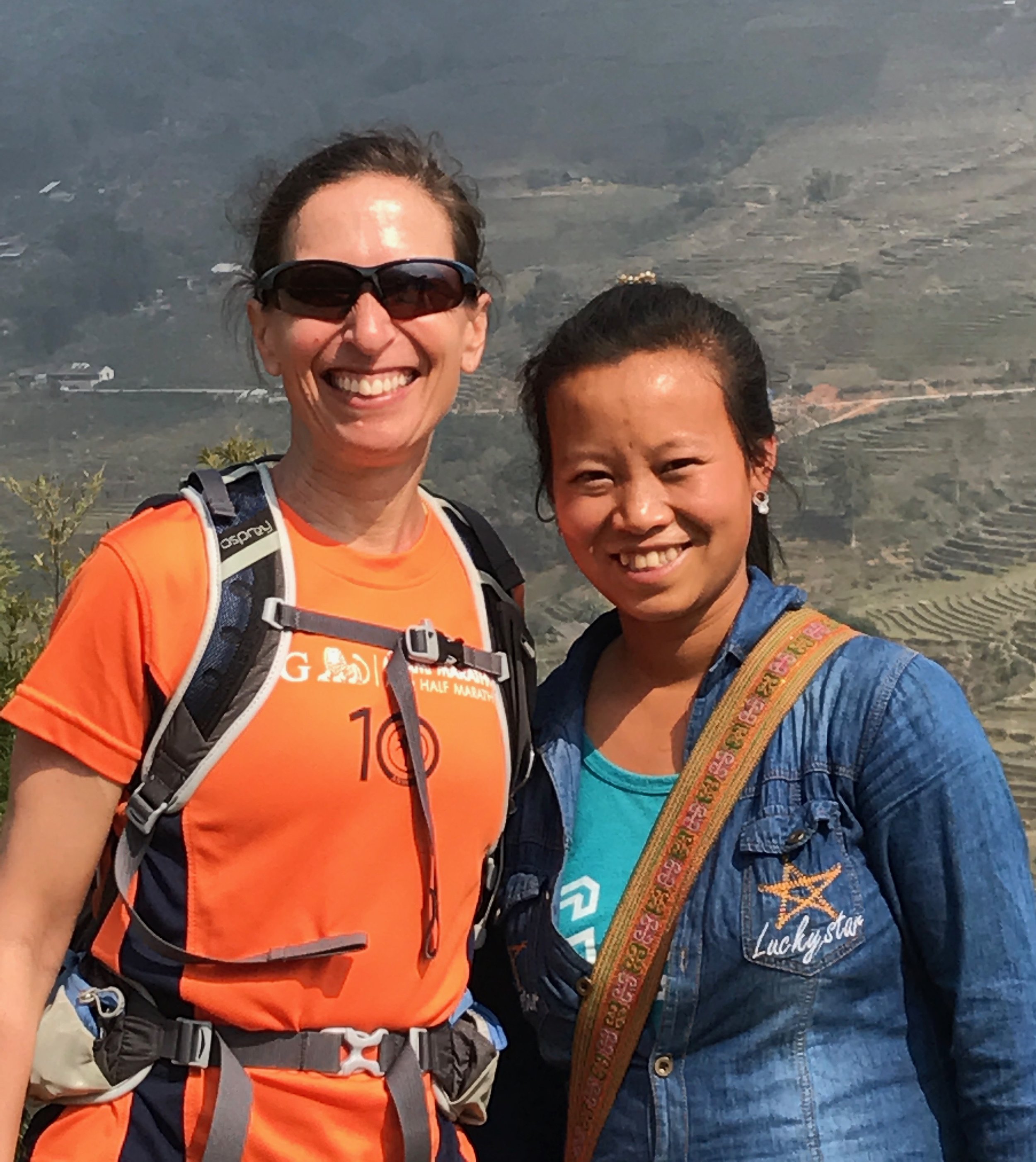 Lisa feeling like a giant with our guide Soa.