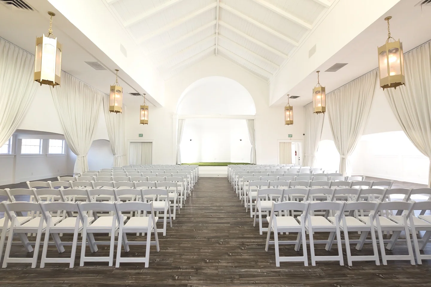 Main Room View from Kitchen Facing Stage - Room Set for 150 Guests