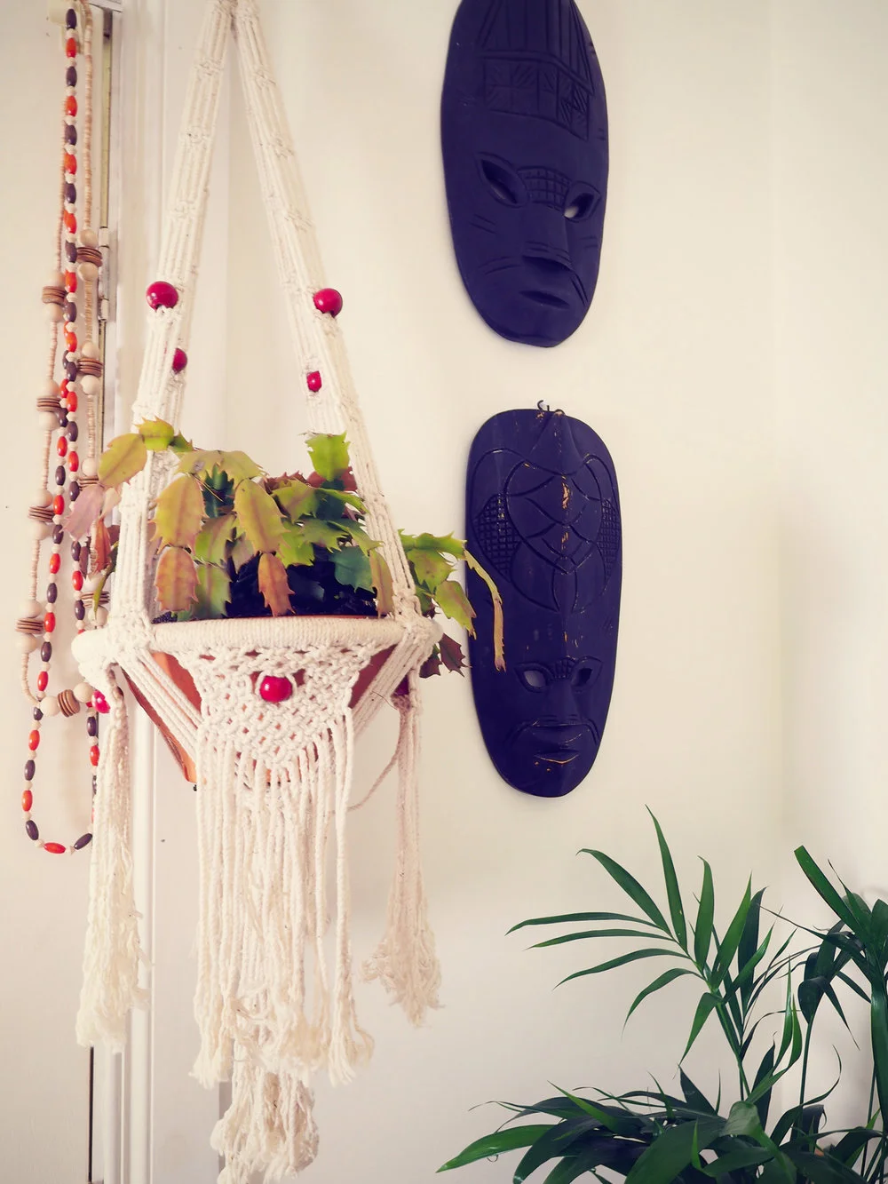 eclectic home decor - macrame hanging planter, tiki masks