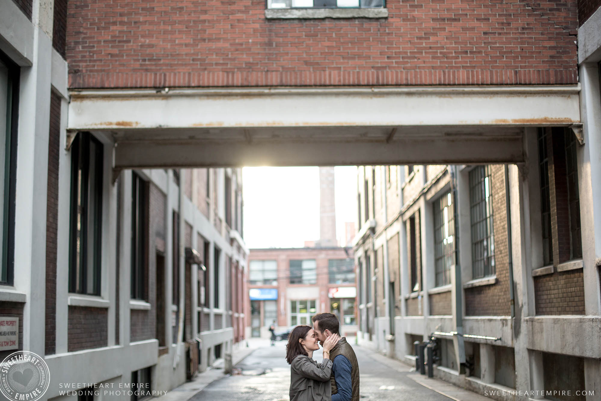 Couple kissing lovingly in an alleyway, Leslieville engagement photos