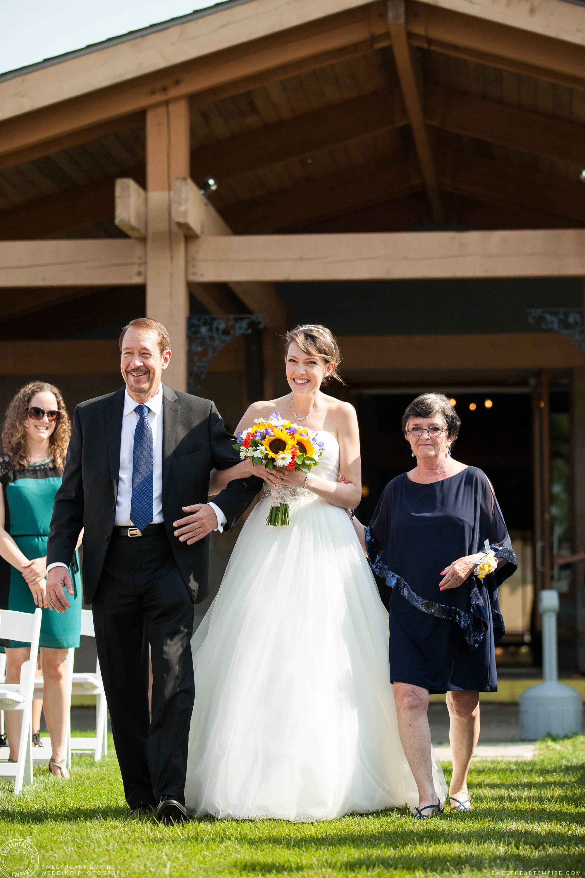 Bride bursting with excitement as she walks down the aisle at her unplugged wedding at Rockway Vineyards.