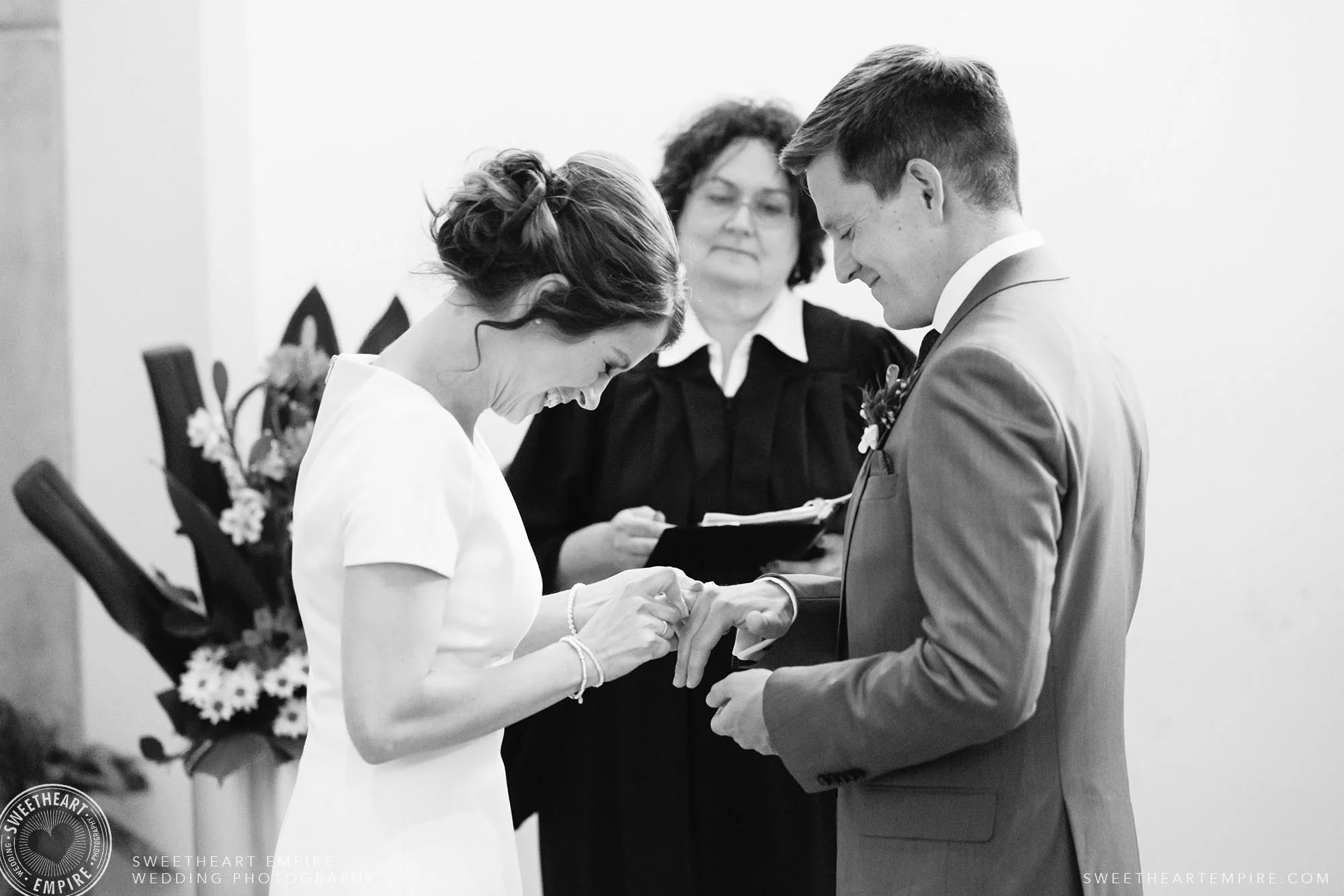 Daniela & Manny giggling during their wedding ceremony at Toronto City Hall.