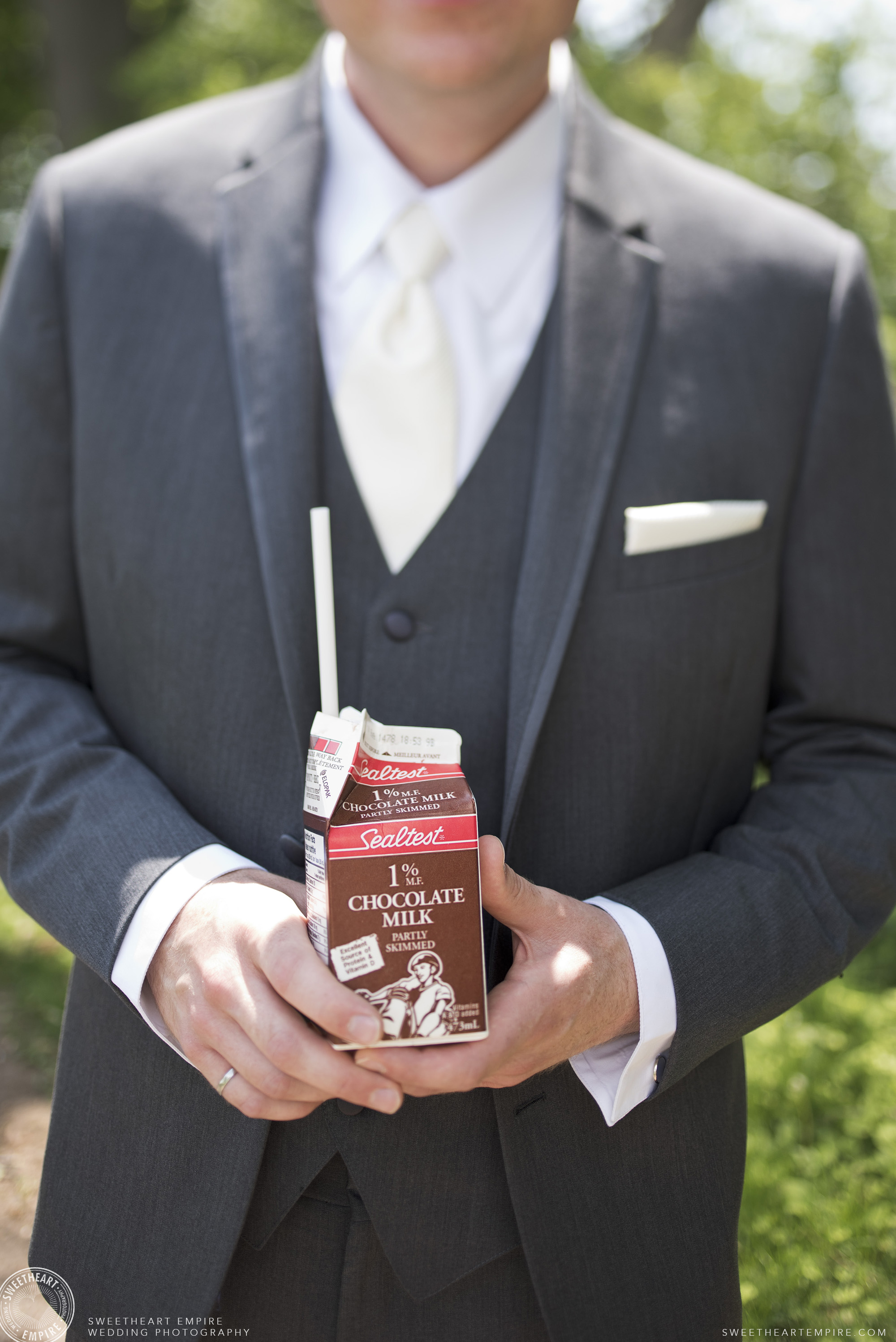 Groom holding a carton of chocolate milk, Oakville Golf Club Wedding