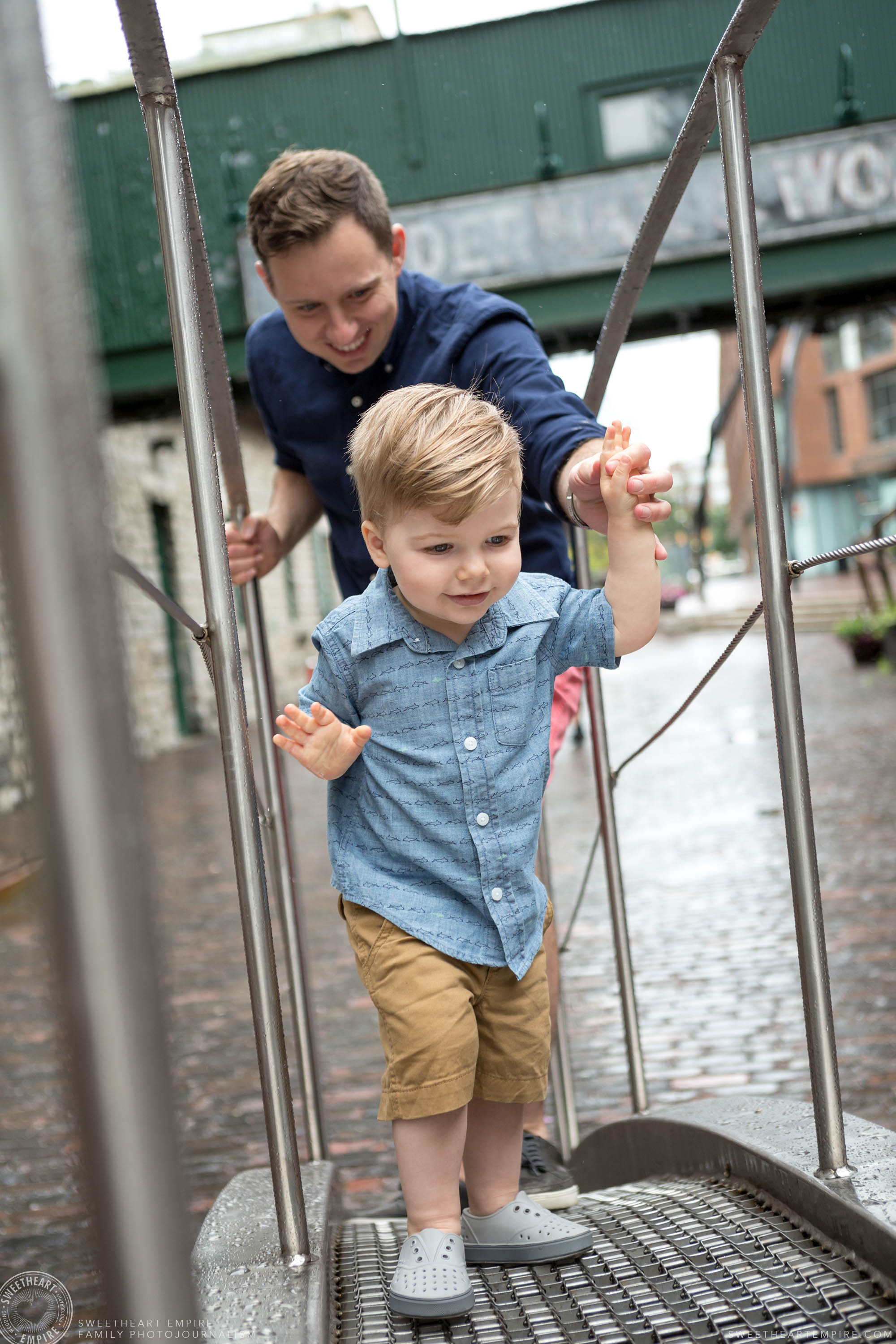 03_Toddler and father climbing sculptures in toronto distillery district.jpg