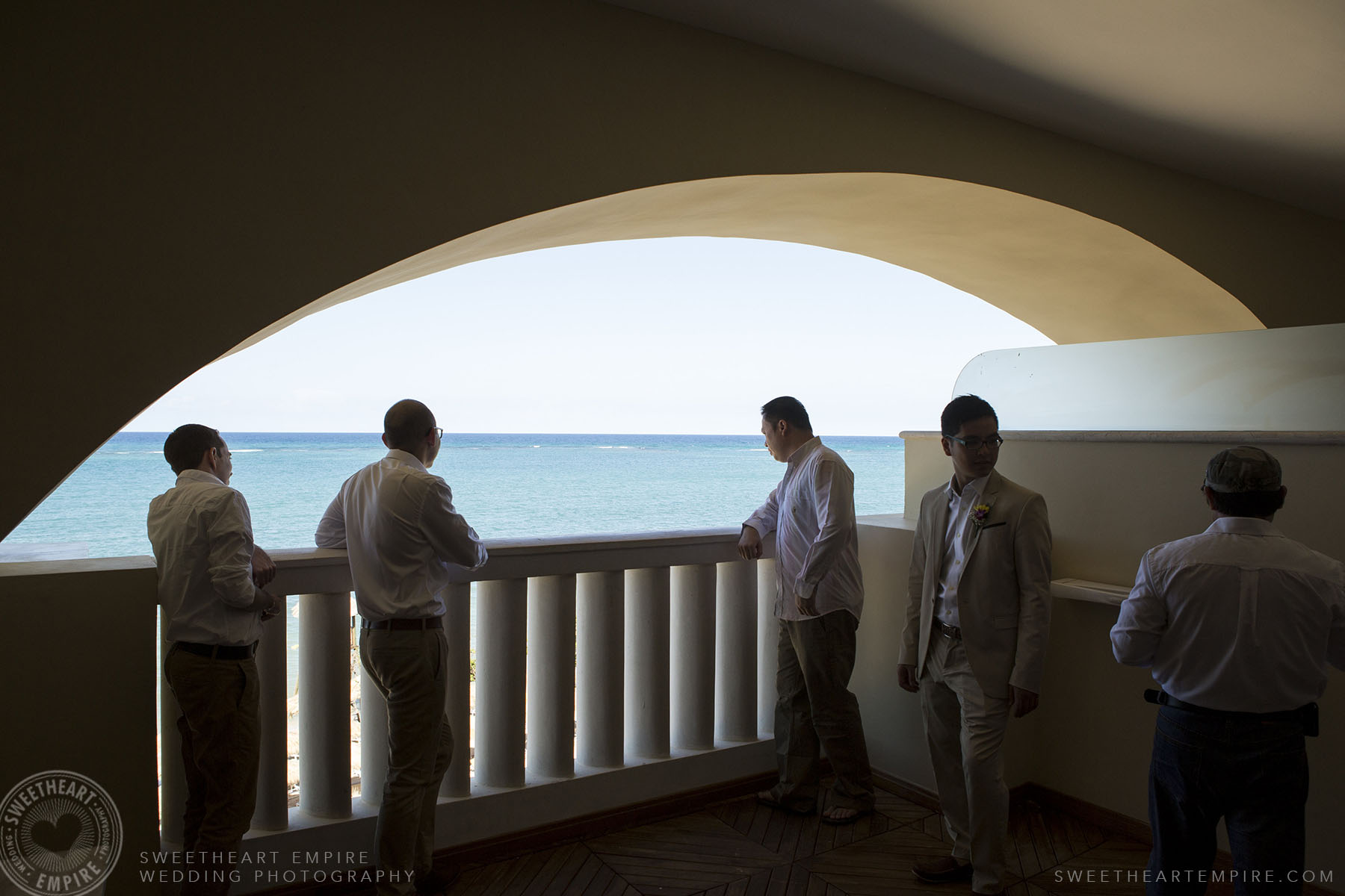 Groom and groomsmen looking at the ocean; Iberostar Grand Hotel Rose Hall, in Montego Bay, Jamaica