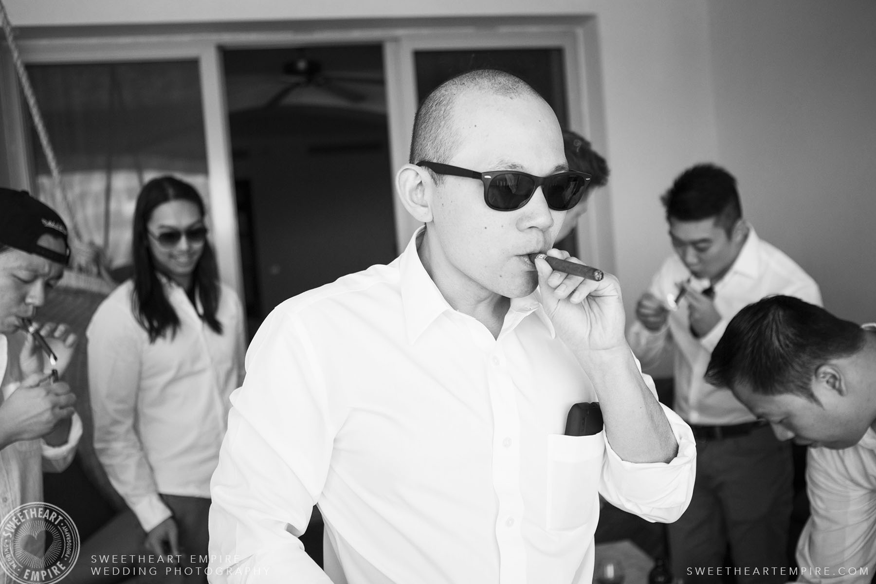 Groomsman smoking a cigar; Iberostar Grand Hotel Rose Hall, in Montego Bay, Jamaica