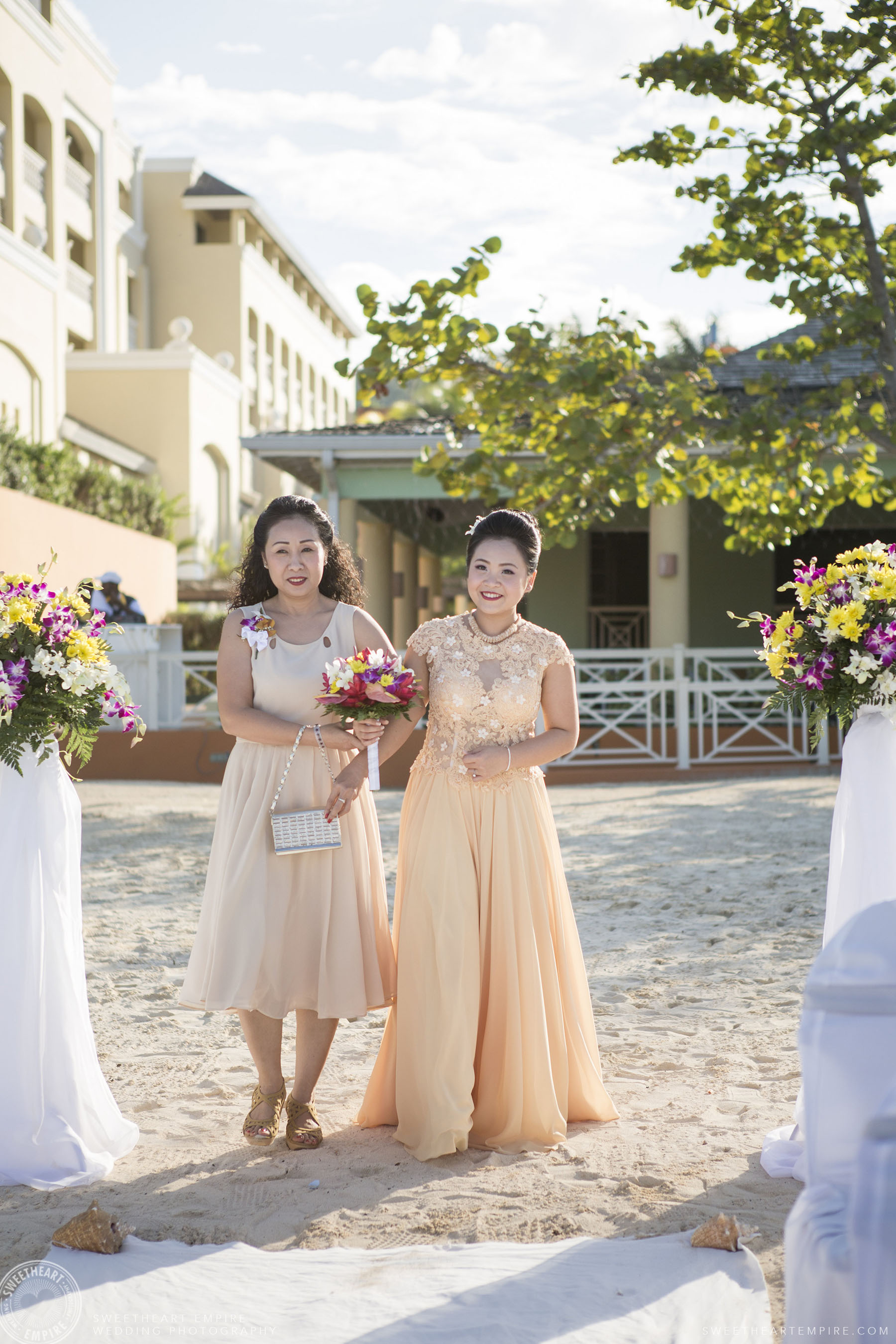 Bride walking down the aisle with her mother; Iberostar Grand Hotel Rose Hall, in Montego Bay, Jamaica