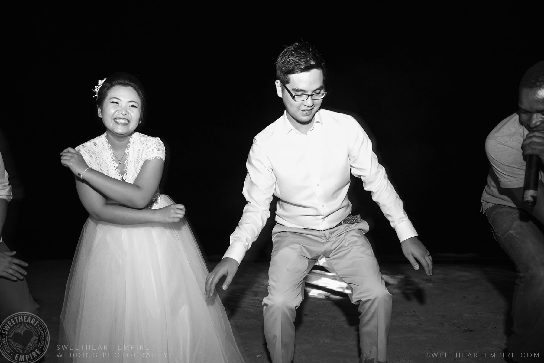 Bride groom dancing on the beach during wedding reception at Iberostar Grand Hotel Rose Hall, in Montego Bay, Jamaica