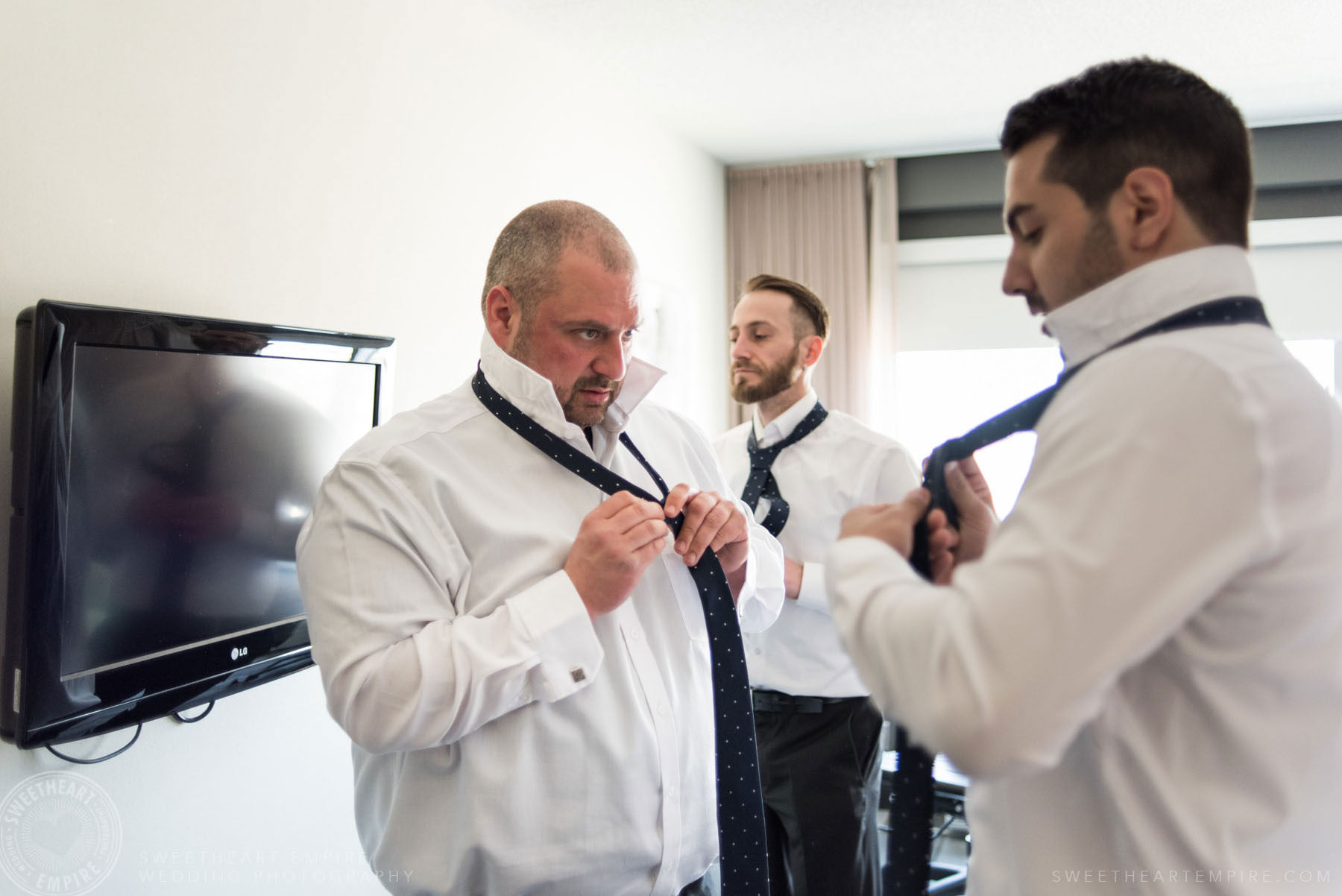 Groom getting ready with his groomsmen;Eagles Nest Golf Club Wedding Photos