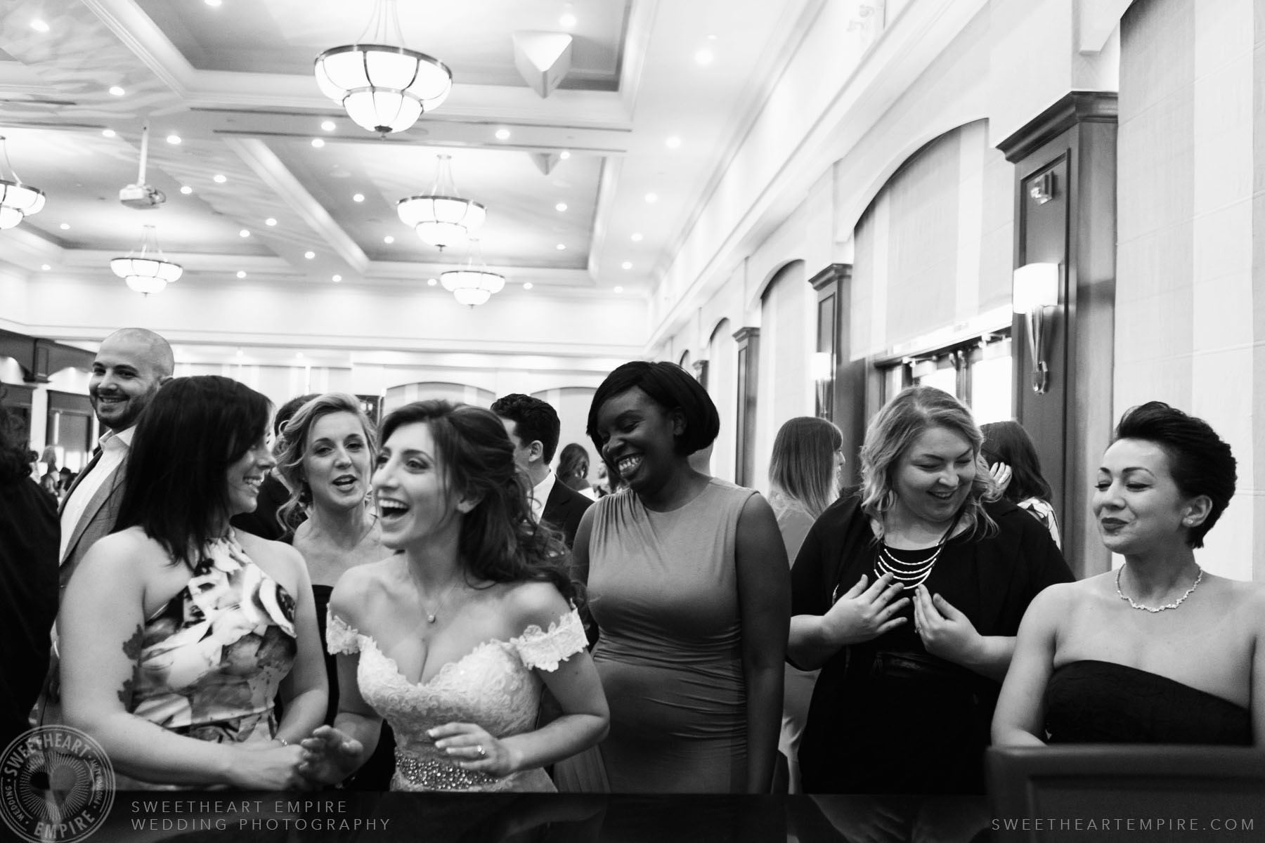 Bride having a drink at the bar with her friends; Eagles Nest Golf Club Wedding